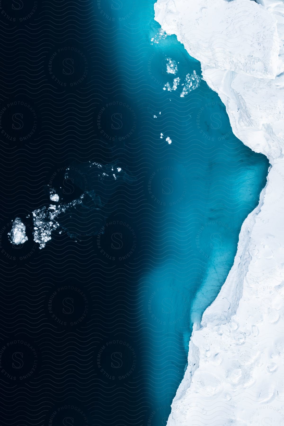 Aerial shot of a glacier edge next to the water