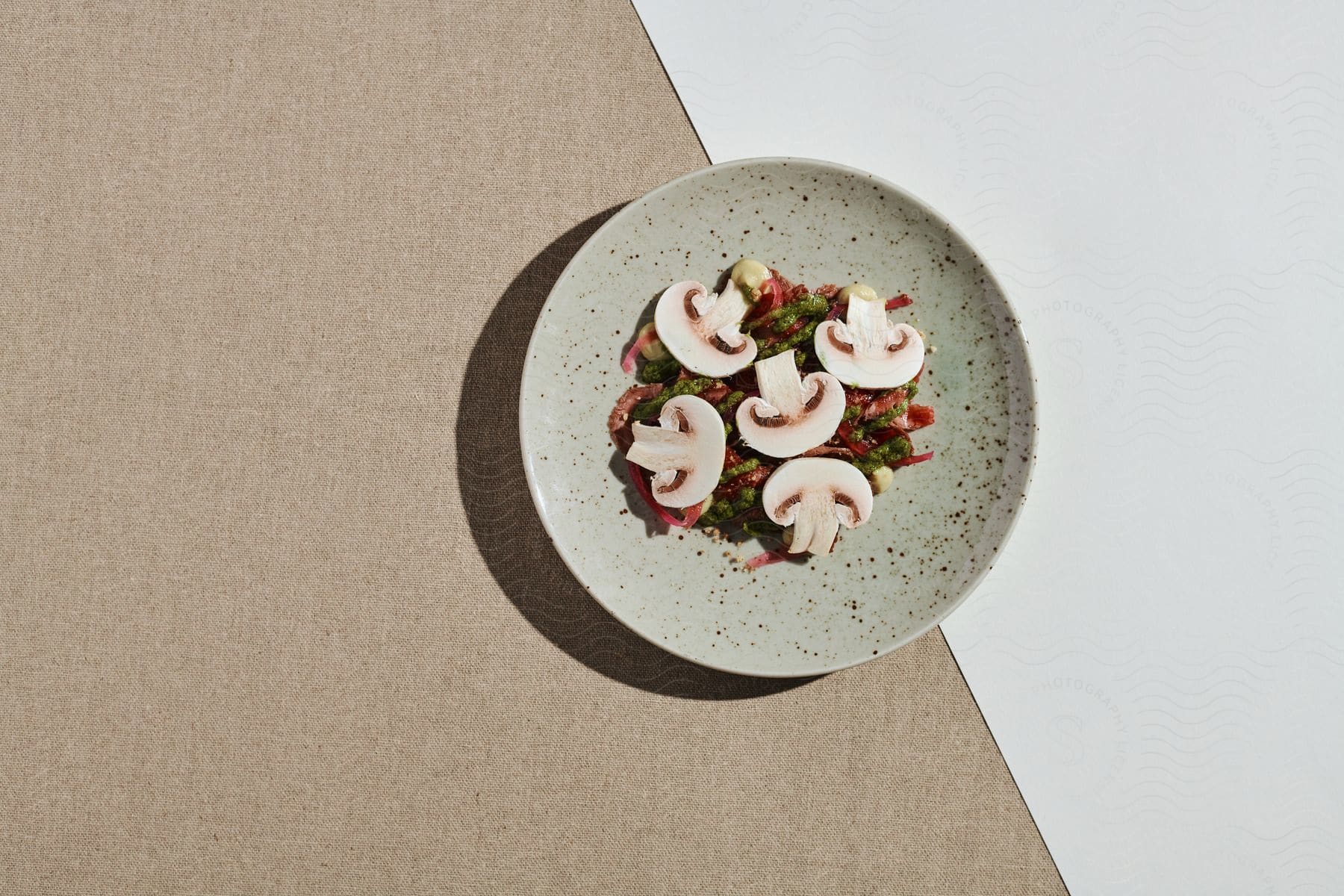 A dish with mushrooms arranged on a gray plate