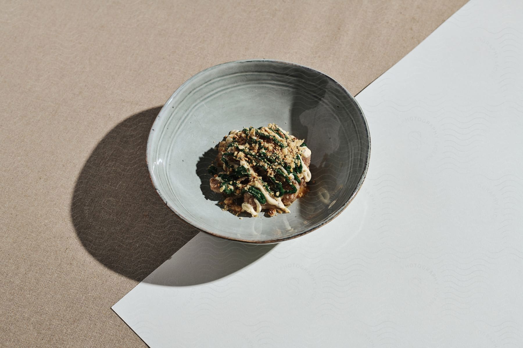 A bowl of prepared food on a colorful background in the daytime