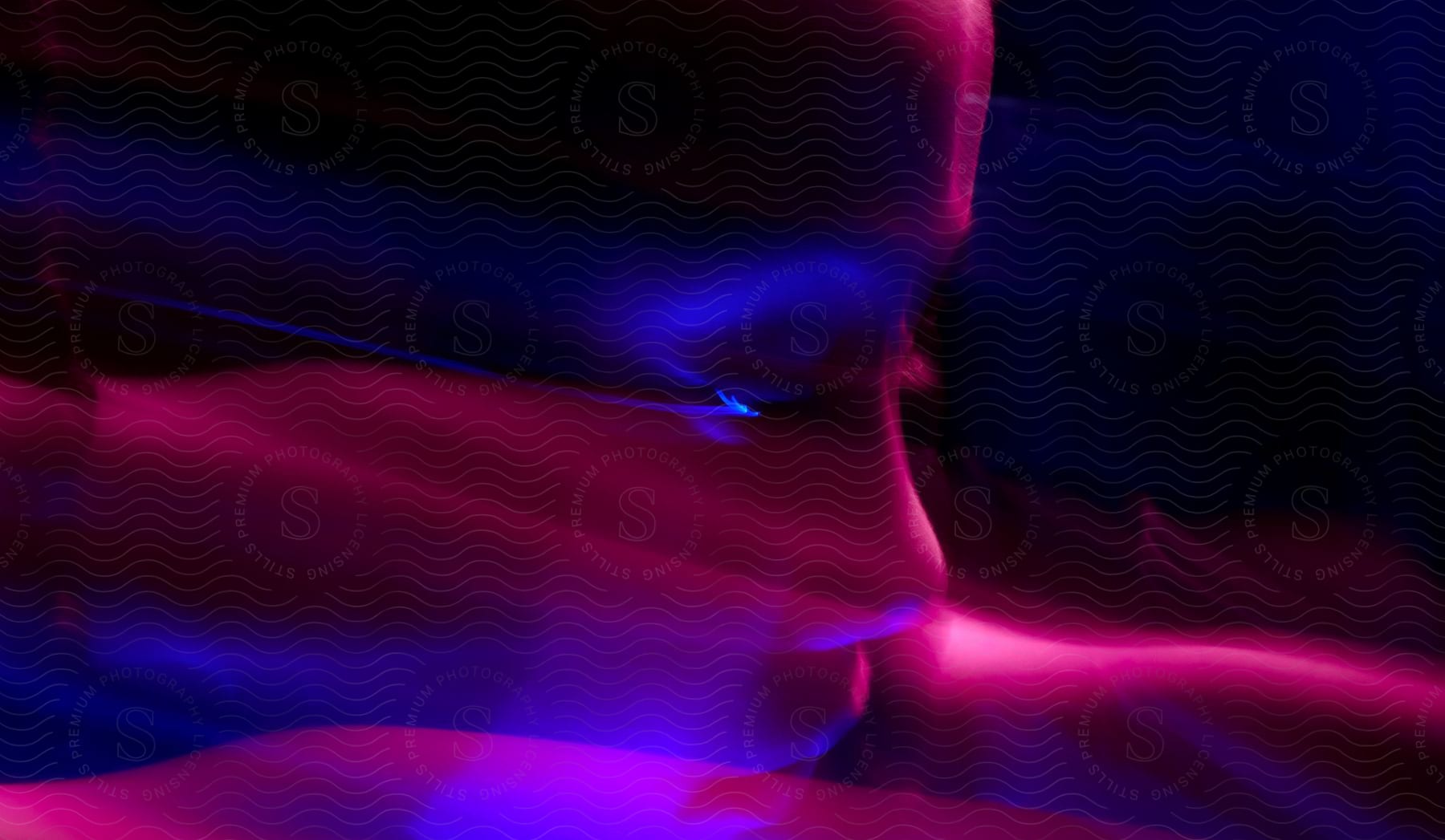 Child under blue and purple lights with motion blur