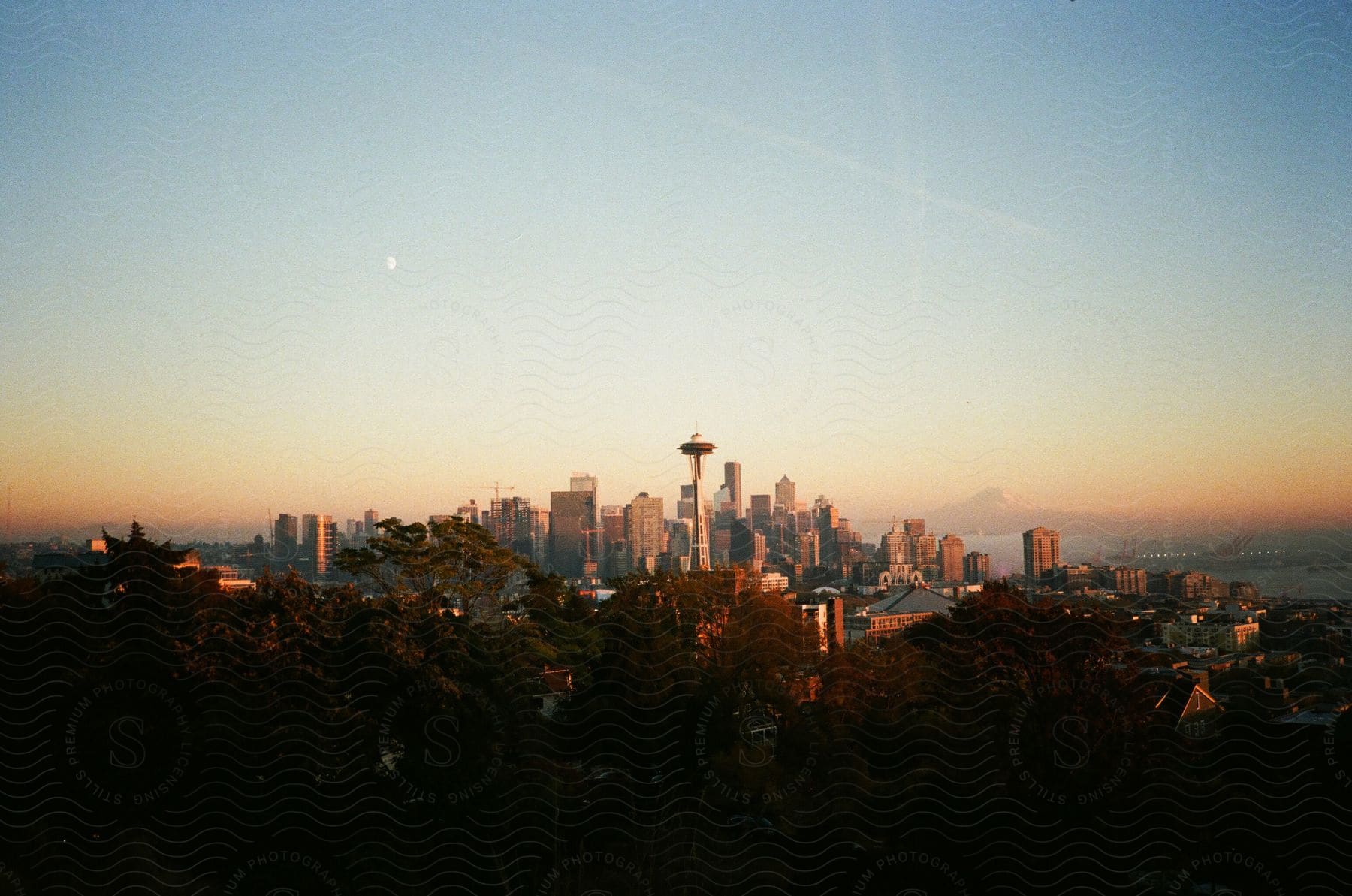 A city with tall buildings during sunset