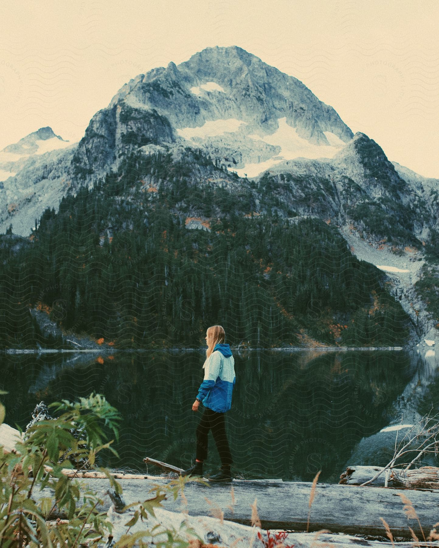 A woman hiking along the base of a mountain