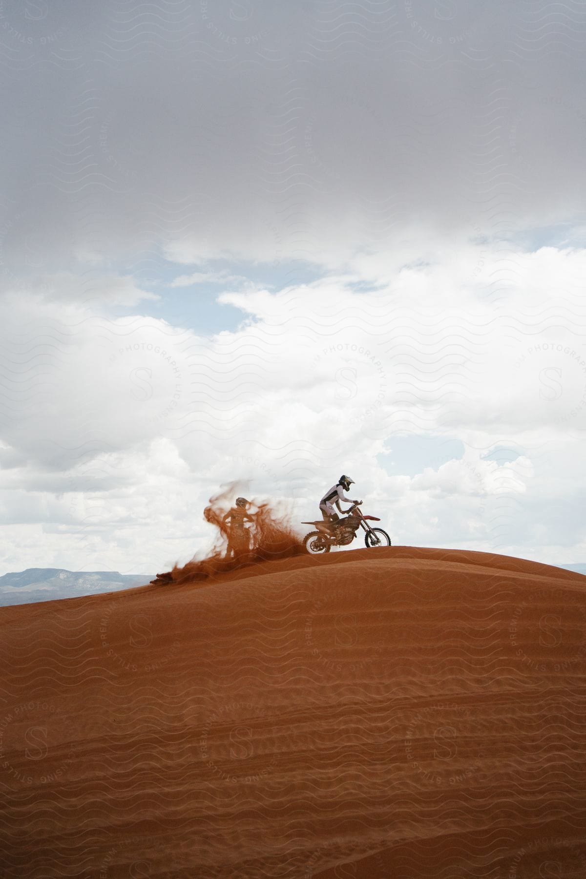 Motorcyclists riding on sand dunes