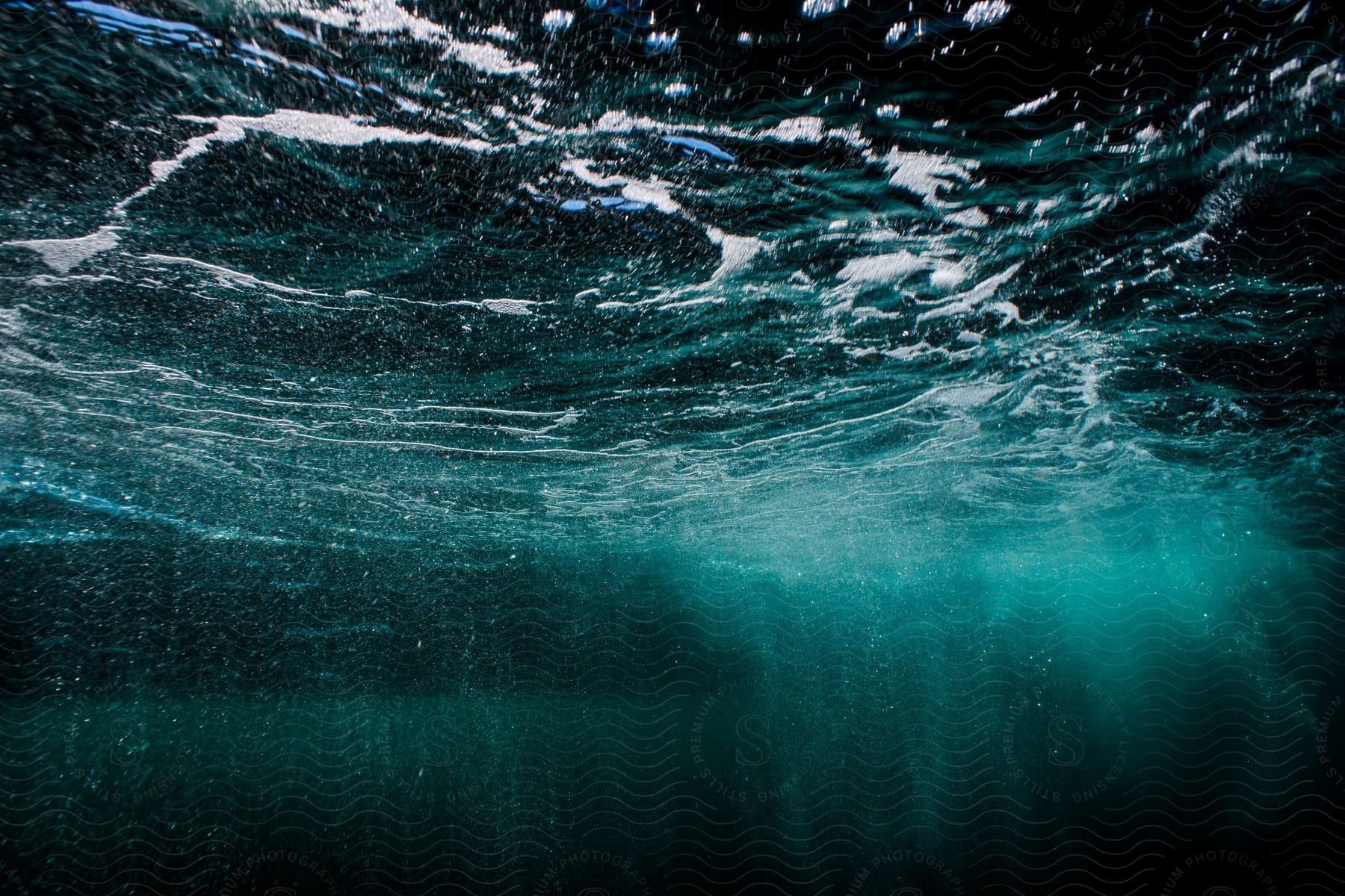 Light and bubbles streak this underwater scene