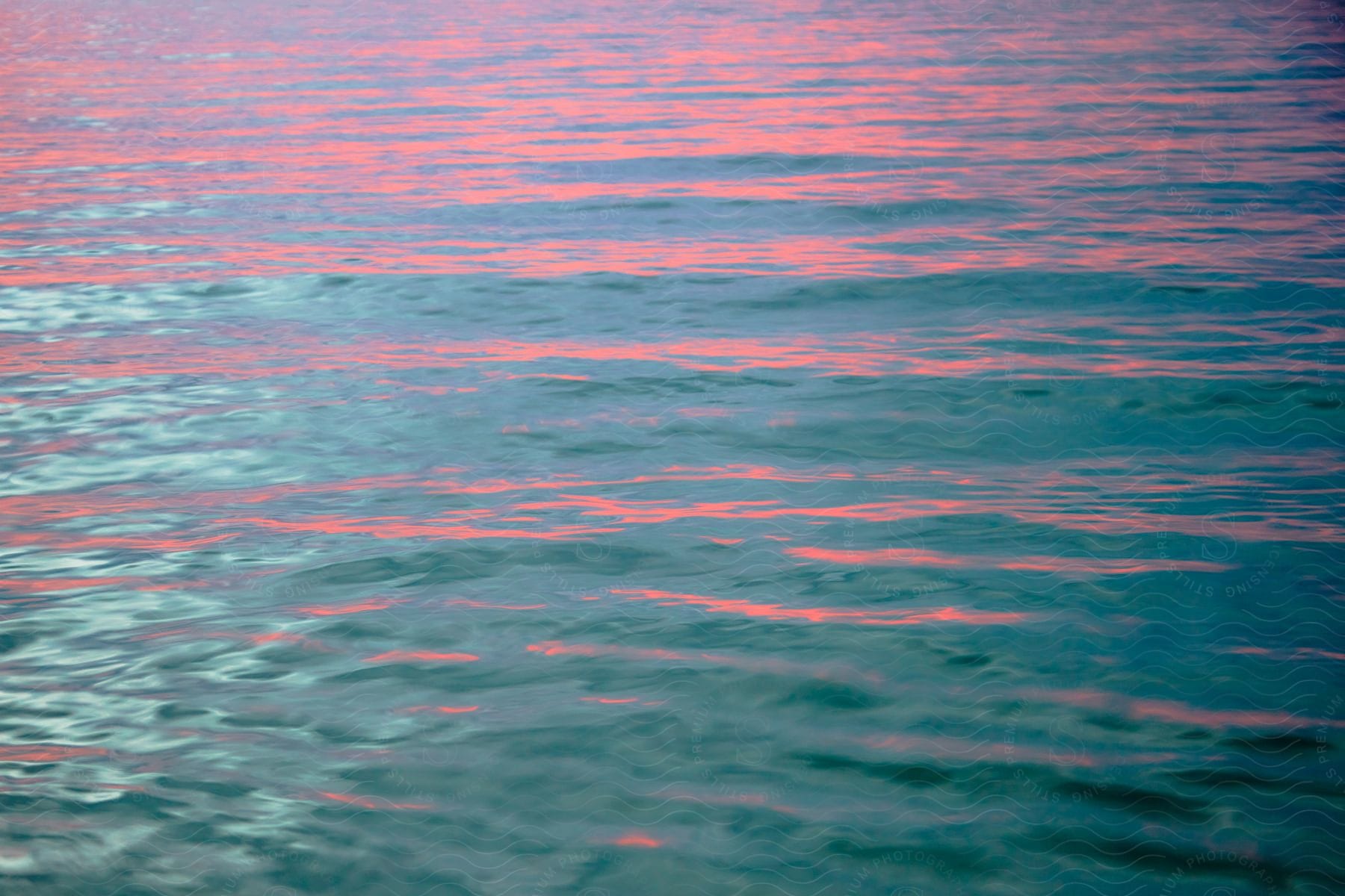 Pink hue reflected on ocean waters