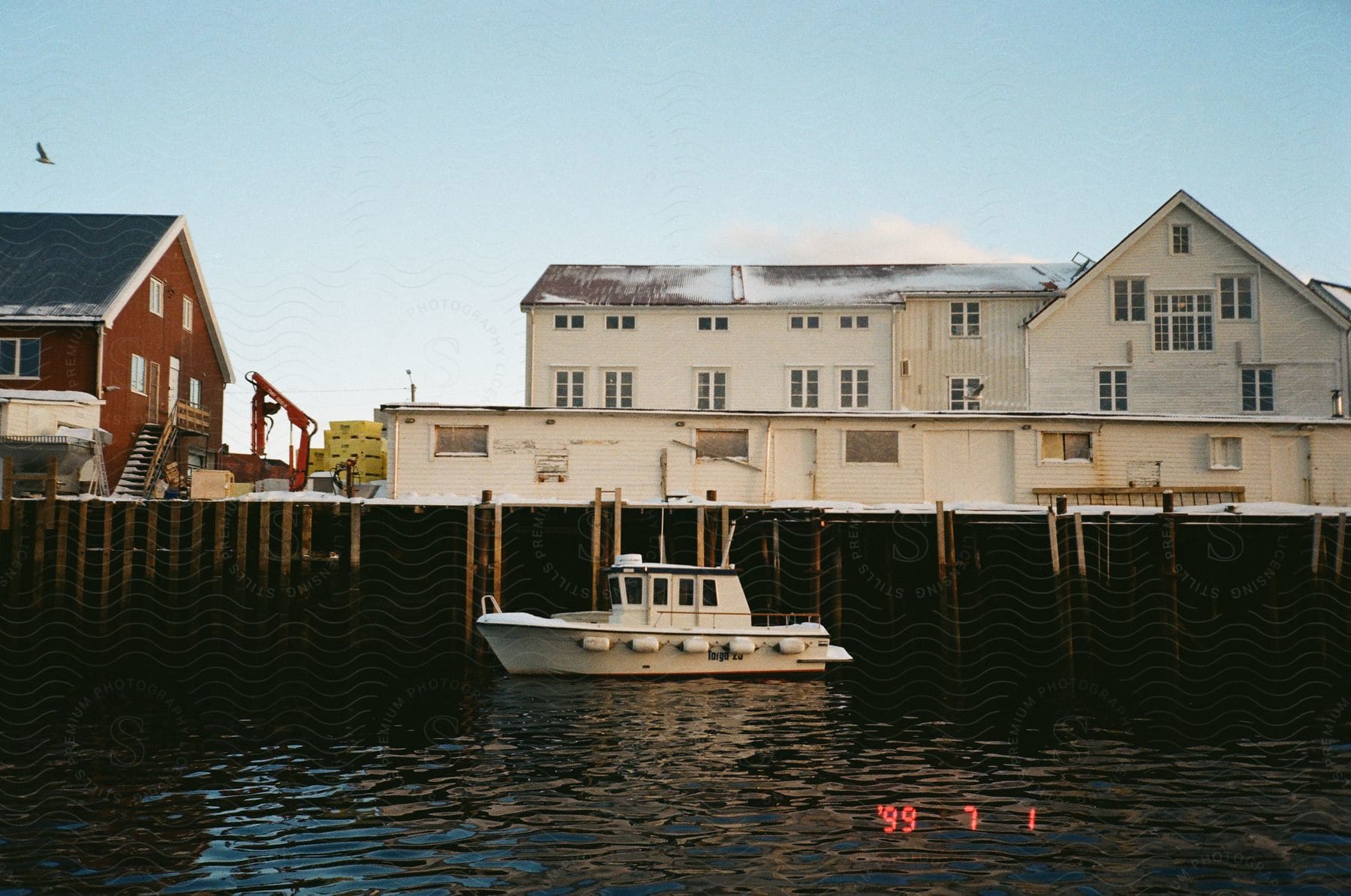 Waterfront buildings and boat sailing on water in a coastal town