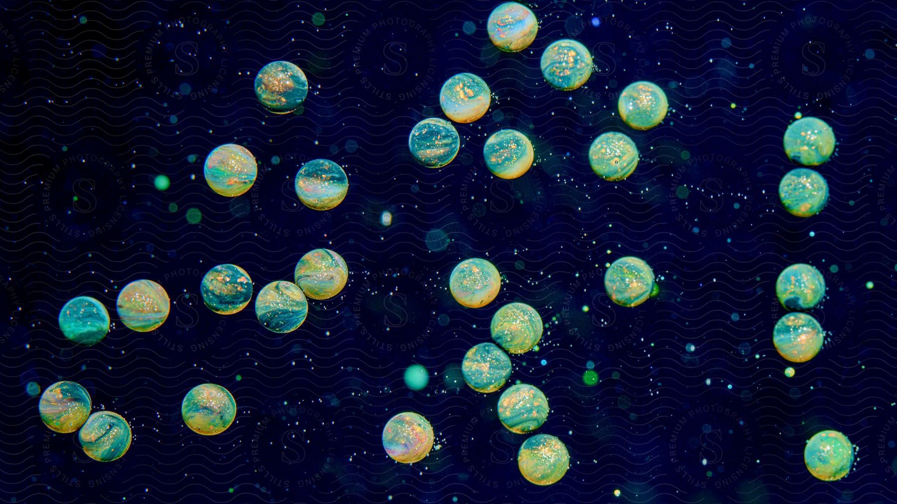 A multicolored artwork depicting planets and stars created with paint in oil