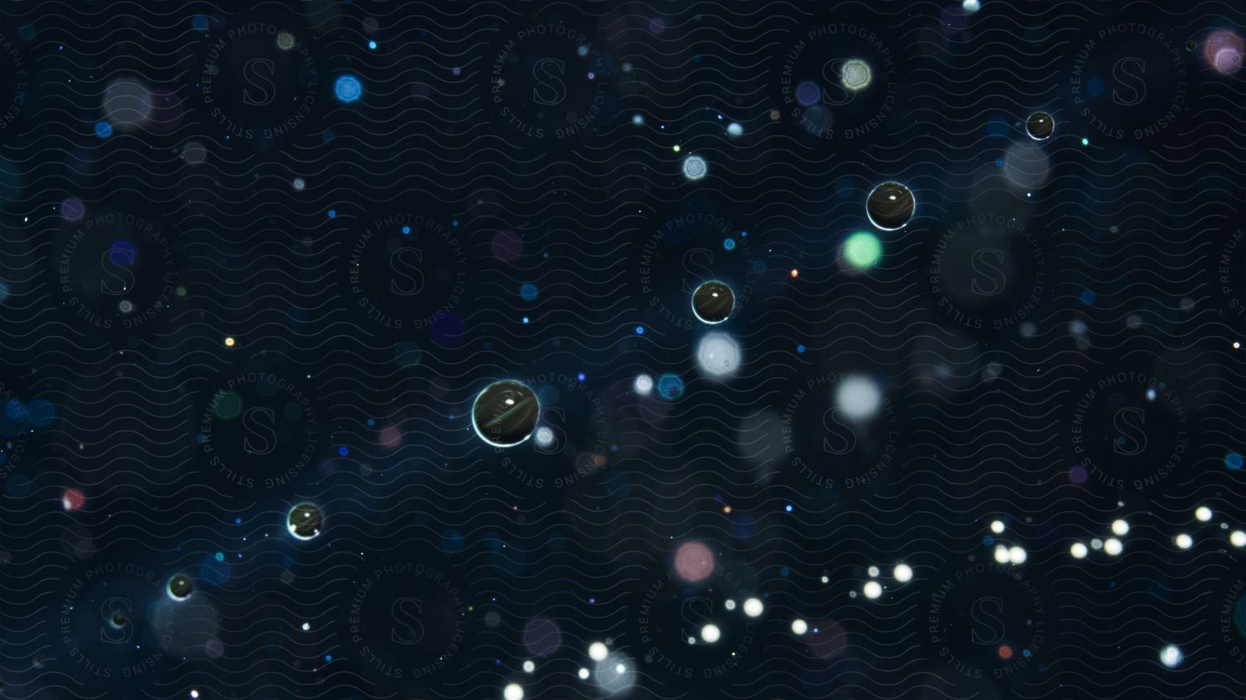 Colorful bubbles shine against a dark background