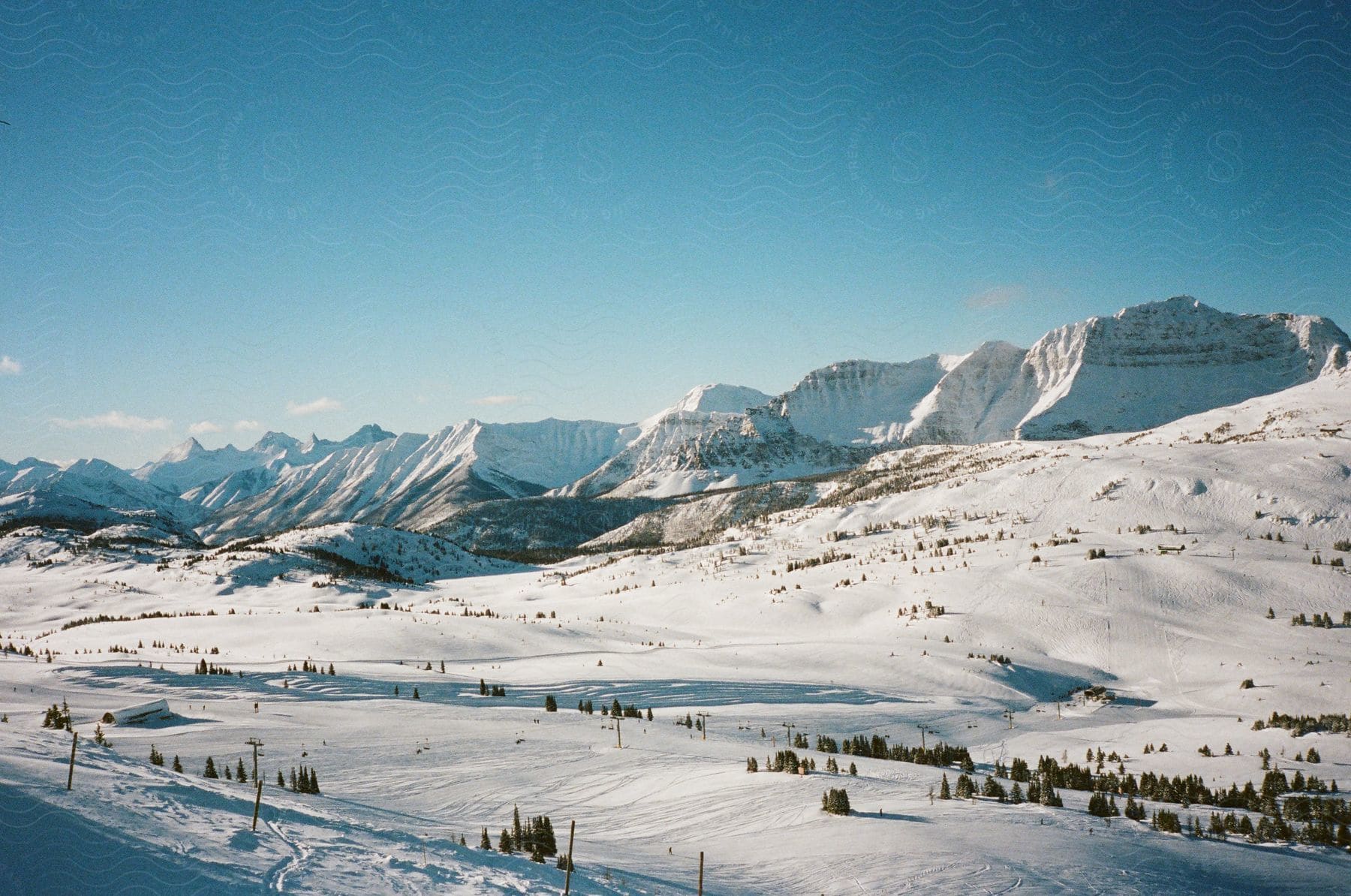 A thick blanket of snow covers the ground on and below a mountain range