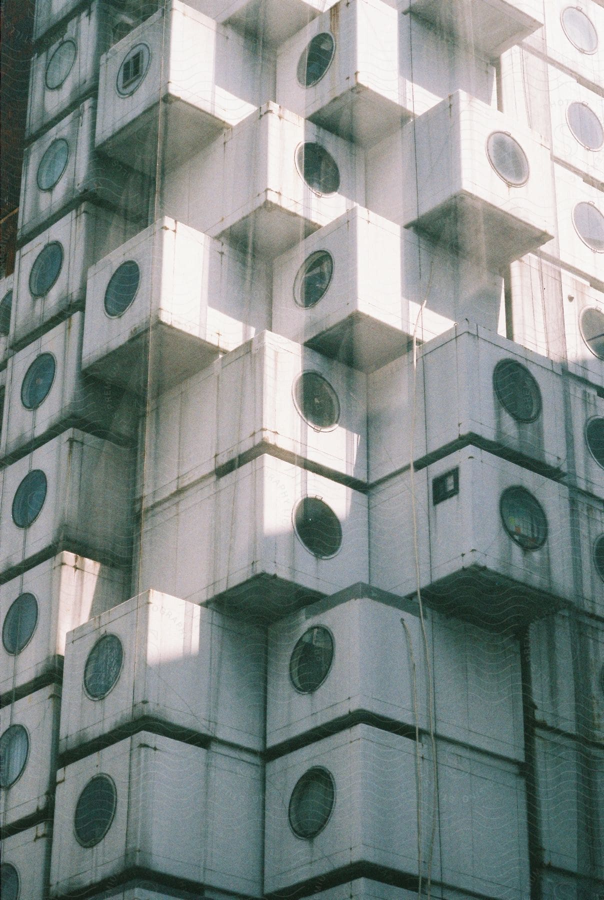 Old shipping containers with windows stacked on top of each other