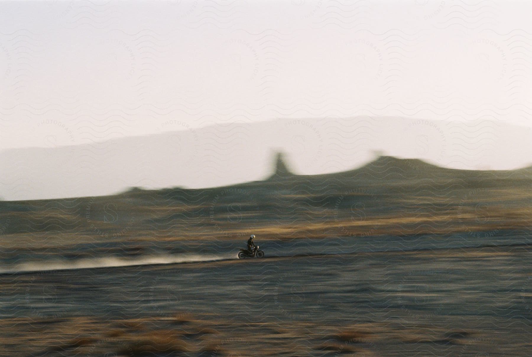 Stock photo of a person riding a dirt bike in the desert