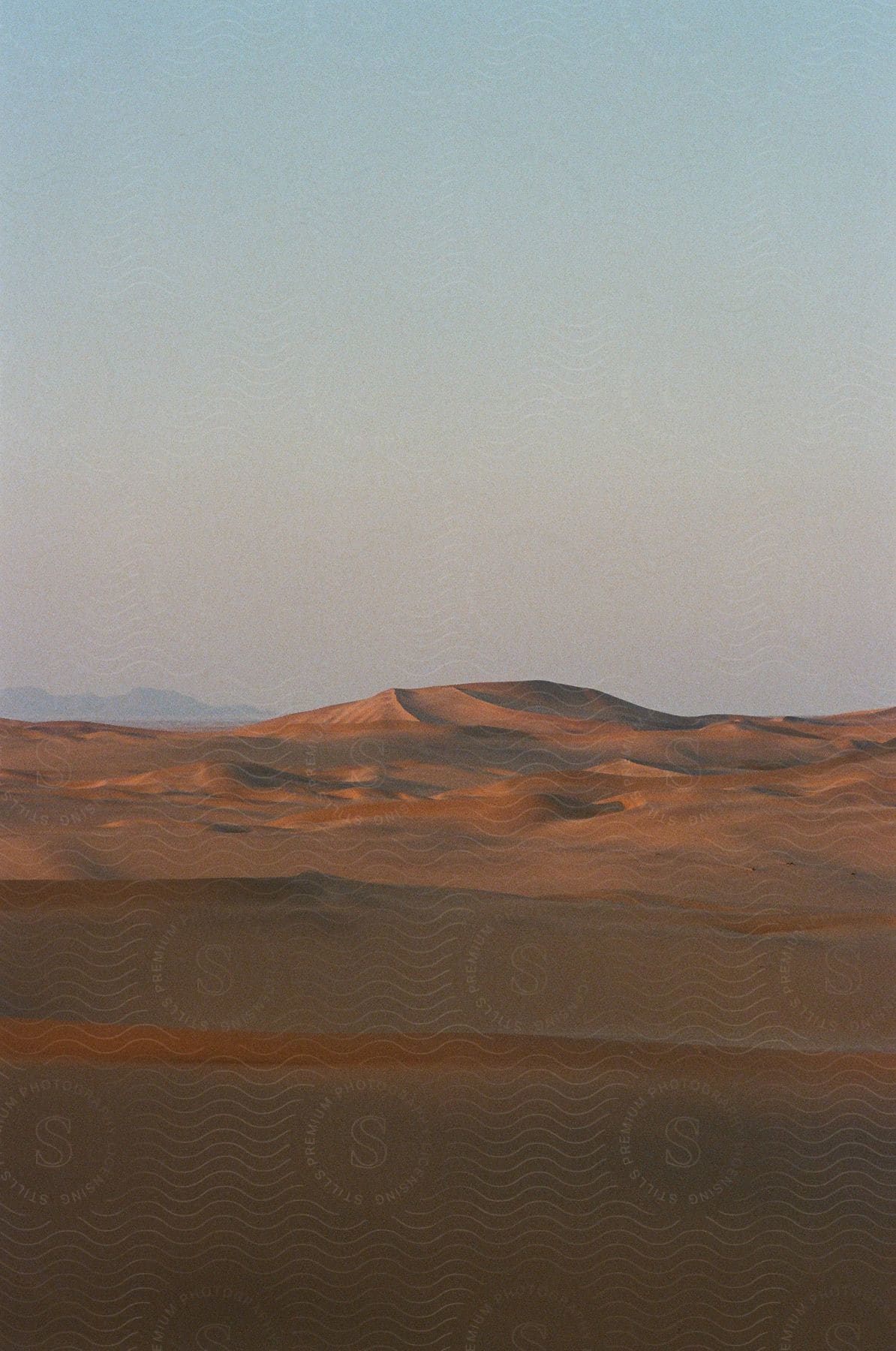 A vast desert landscape with rolling sand dunes creates a mesmerizing tapestry of natures artistry