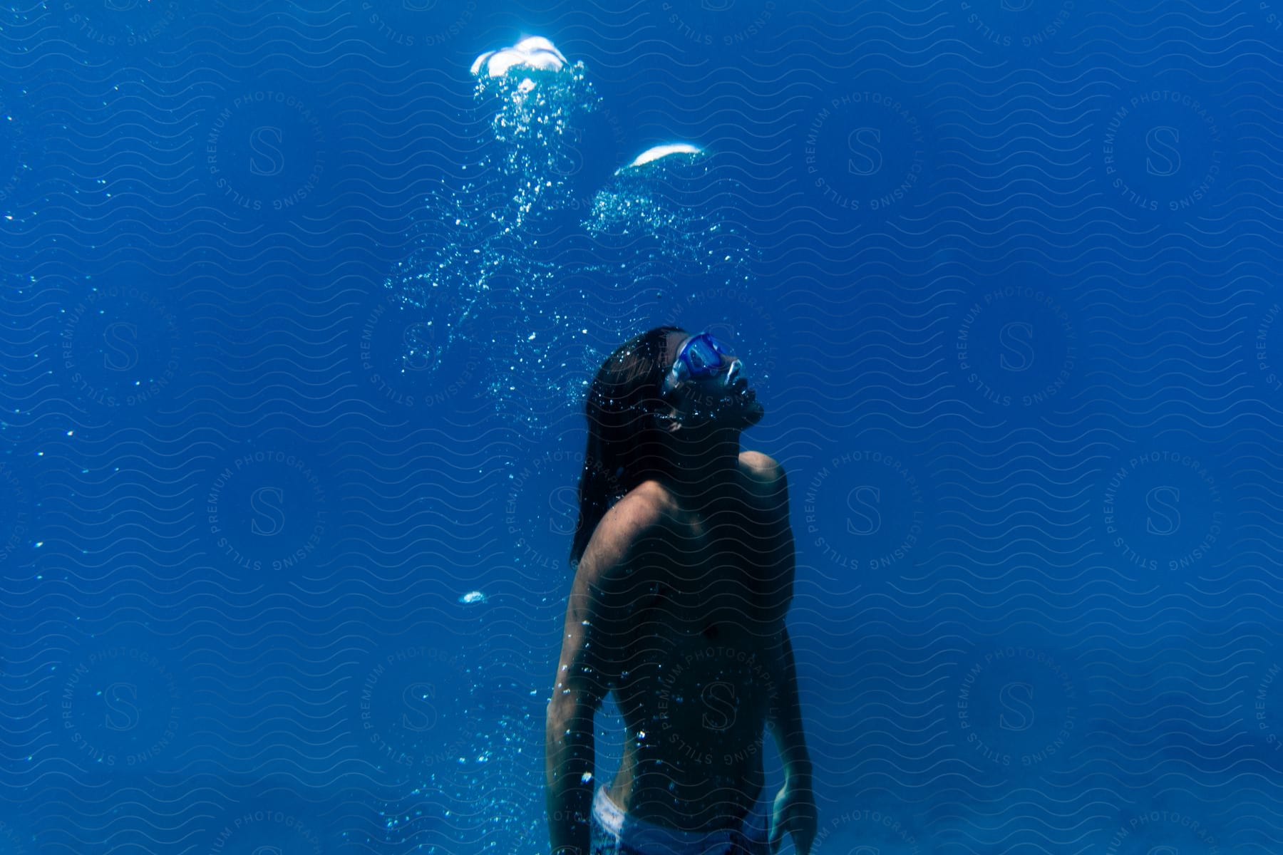 A man diving underwater on a sunny day