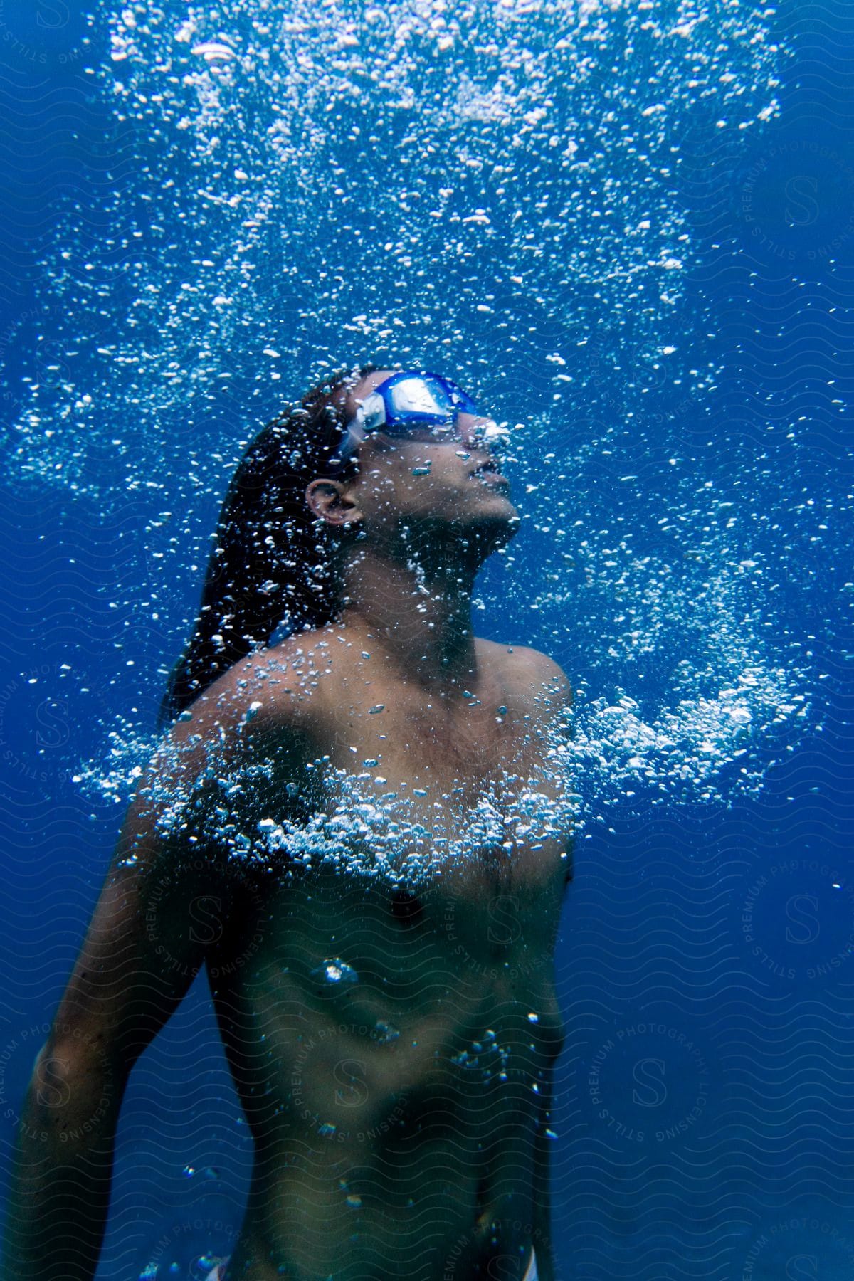 A man swimming underwater in the ocean