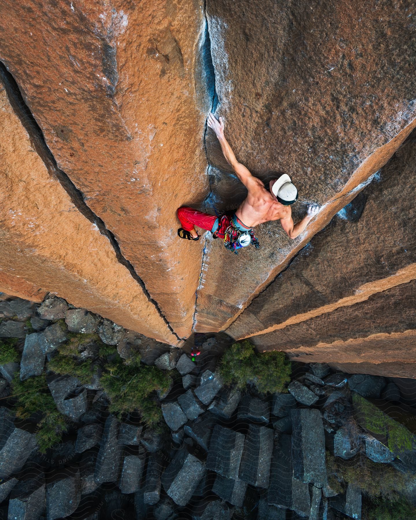 A man climbs up the side of a mountain