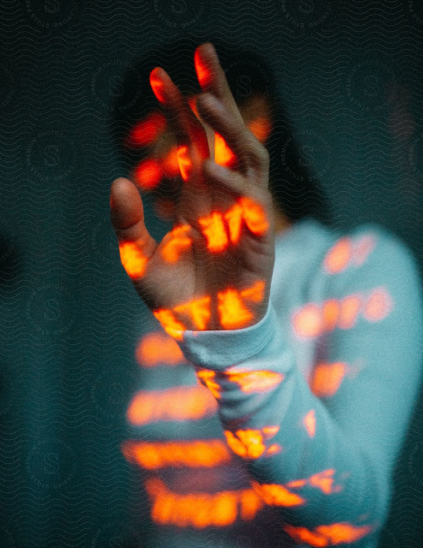 A woman wearing a white long sleeve turtleneck with glowing amber kanji characters projected onto her