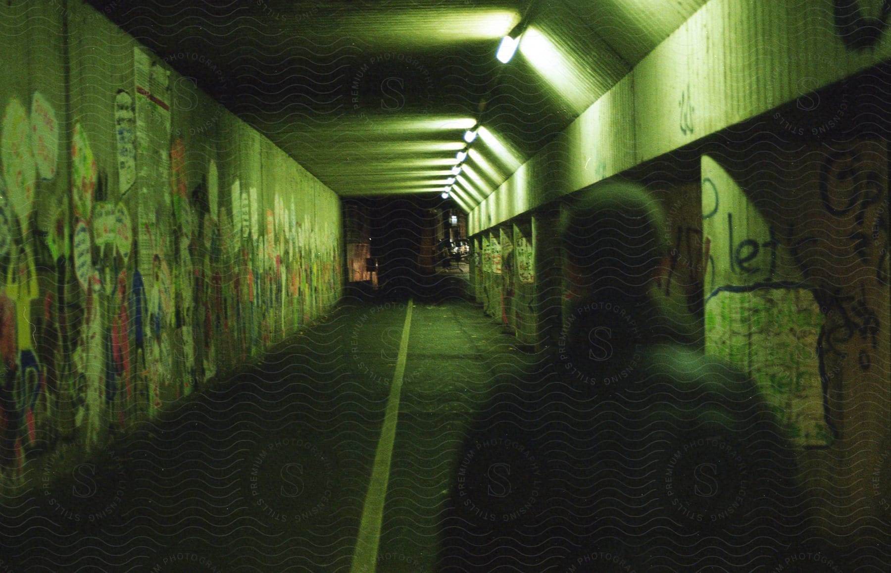 A man is seen walking on a tunnel at night