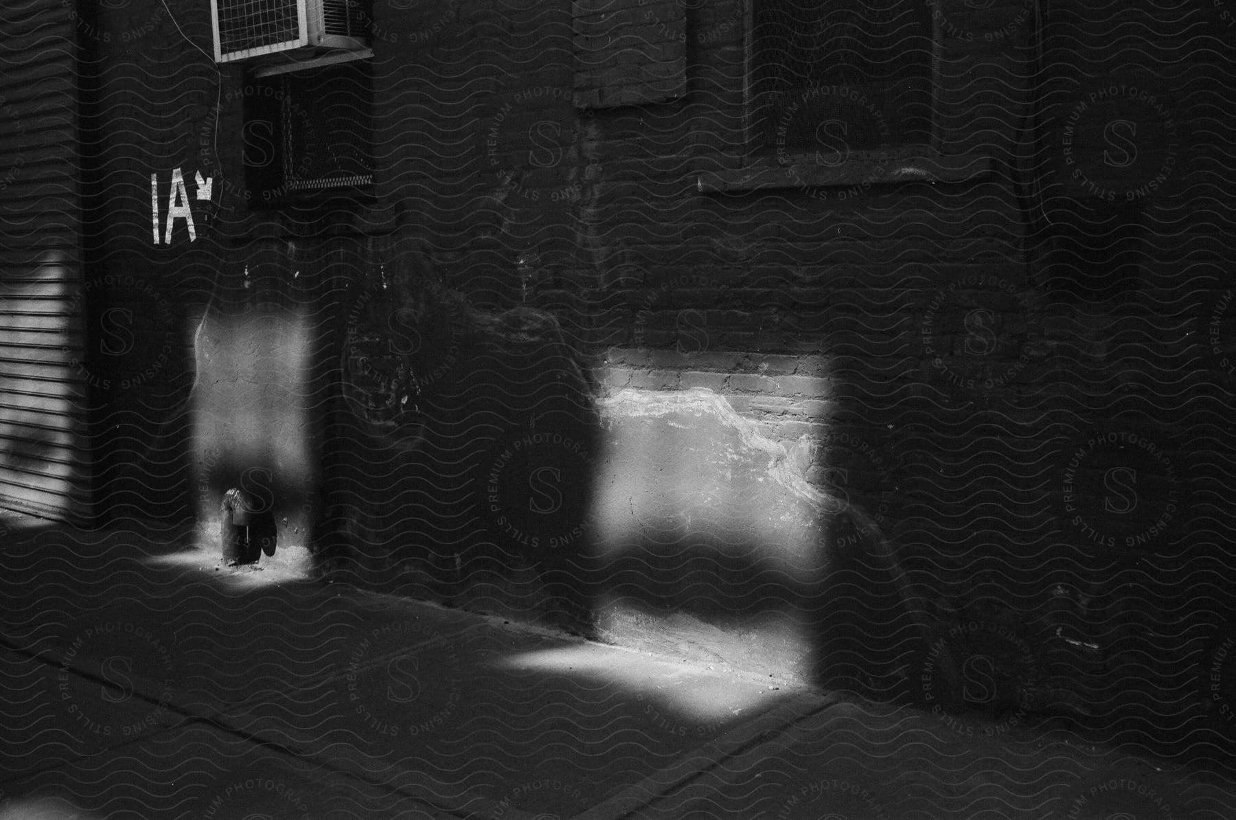 Sunlight shaped as windows projected on a brick apartment building in new york city