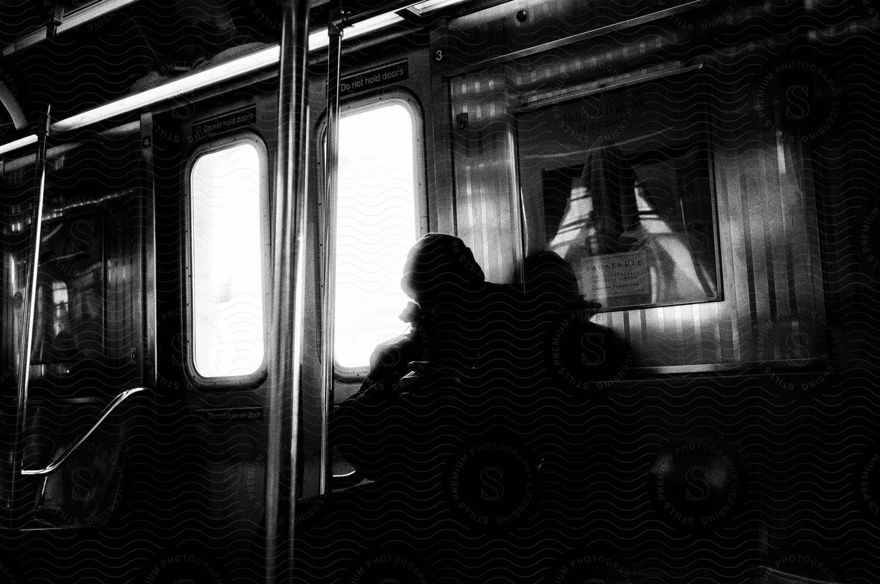A person sitting on a subway car