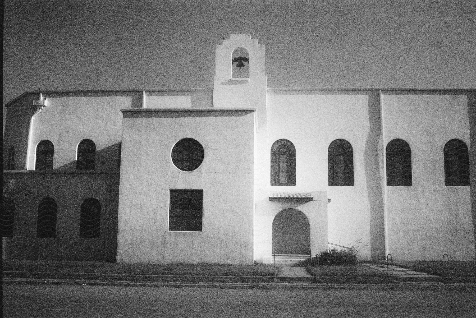 Stock photo of the side of an old church building with a gothic arch window