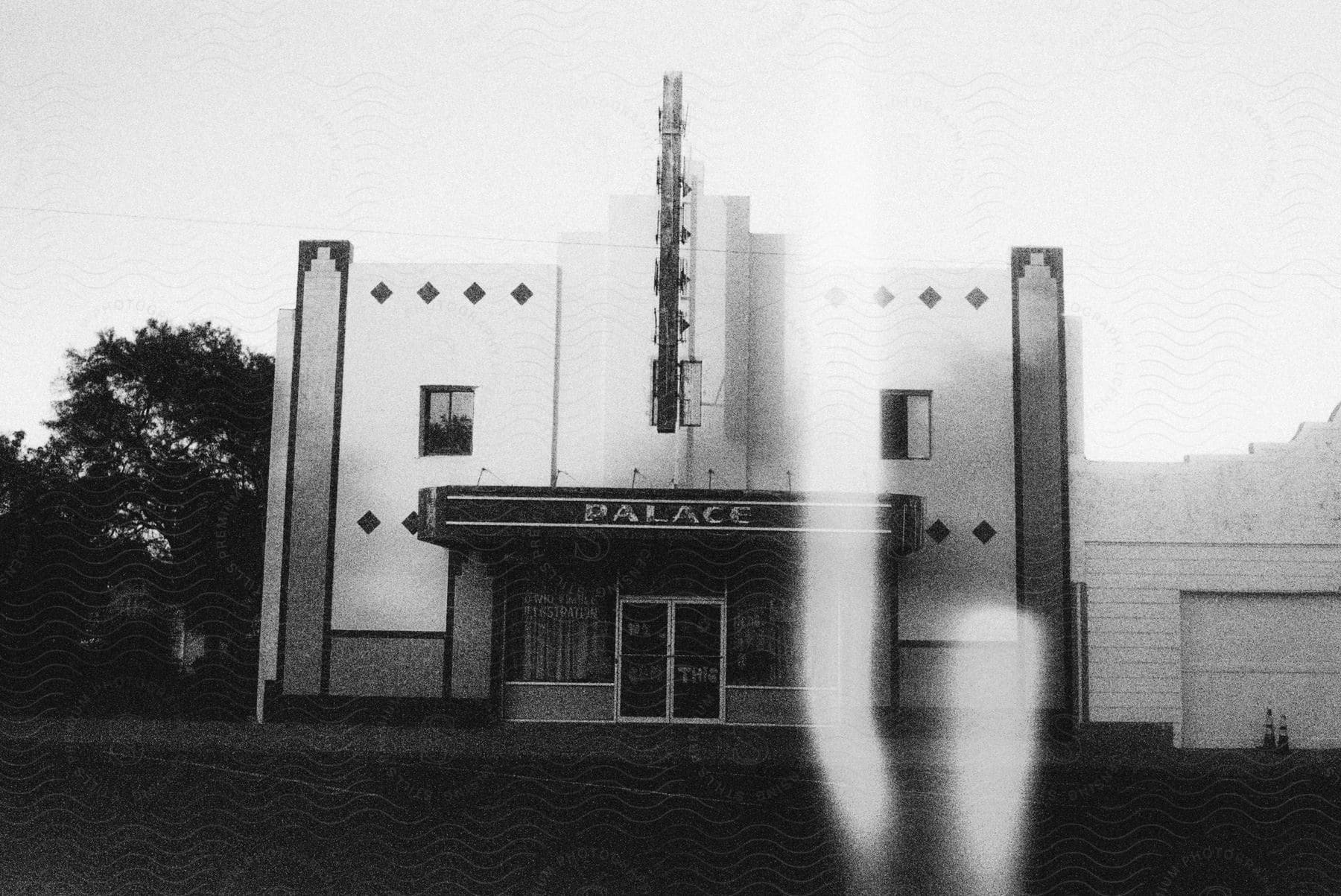 A twostory palace theater is shown in blackandwhite with an overexposure line