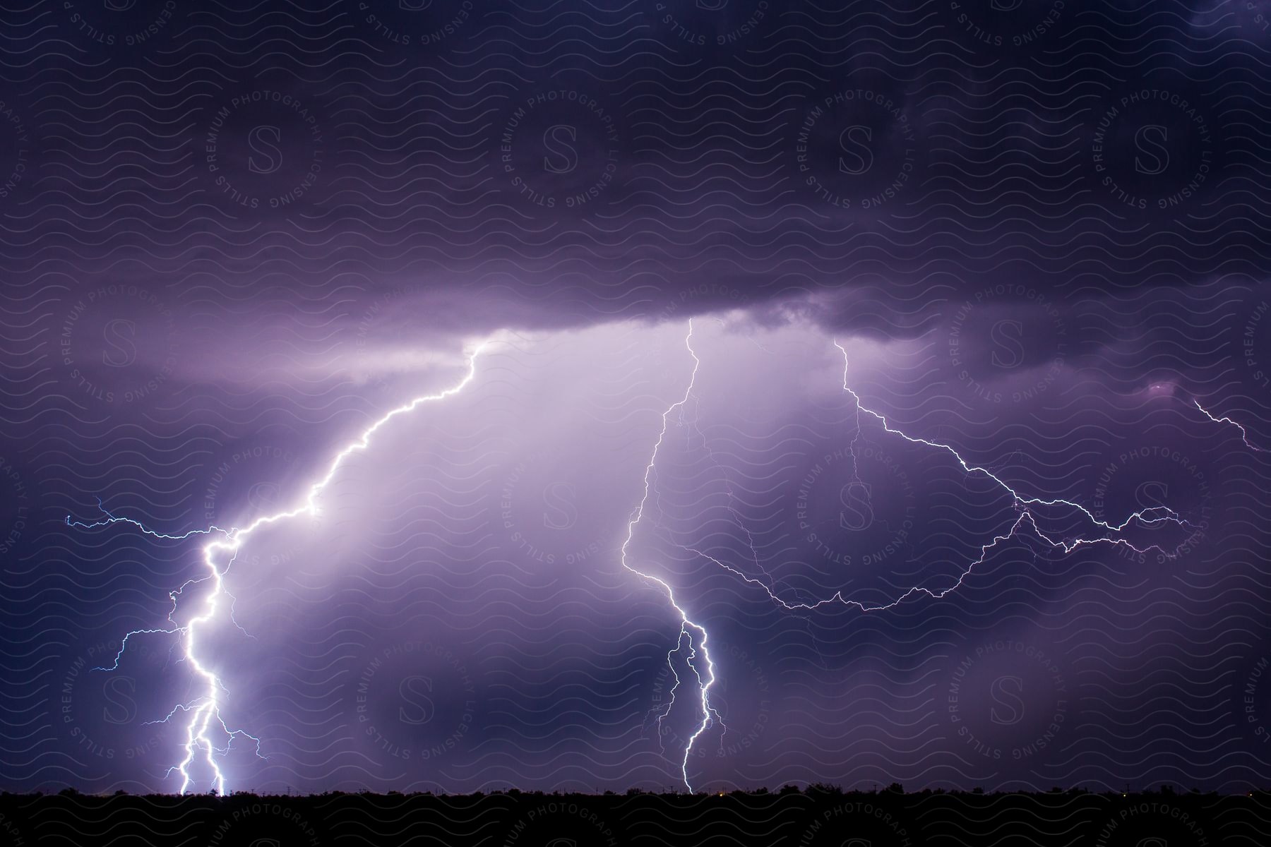 Purple night sky with lightning strikes