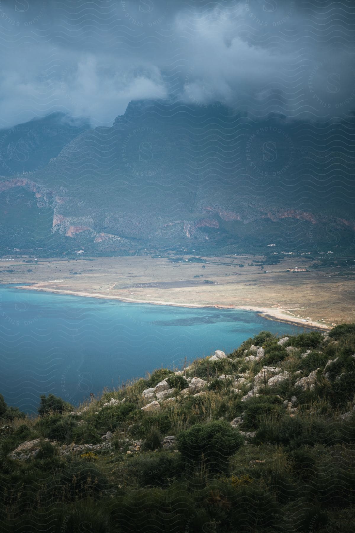 A beach is surrounded by rocky terrain along the coast