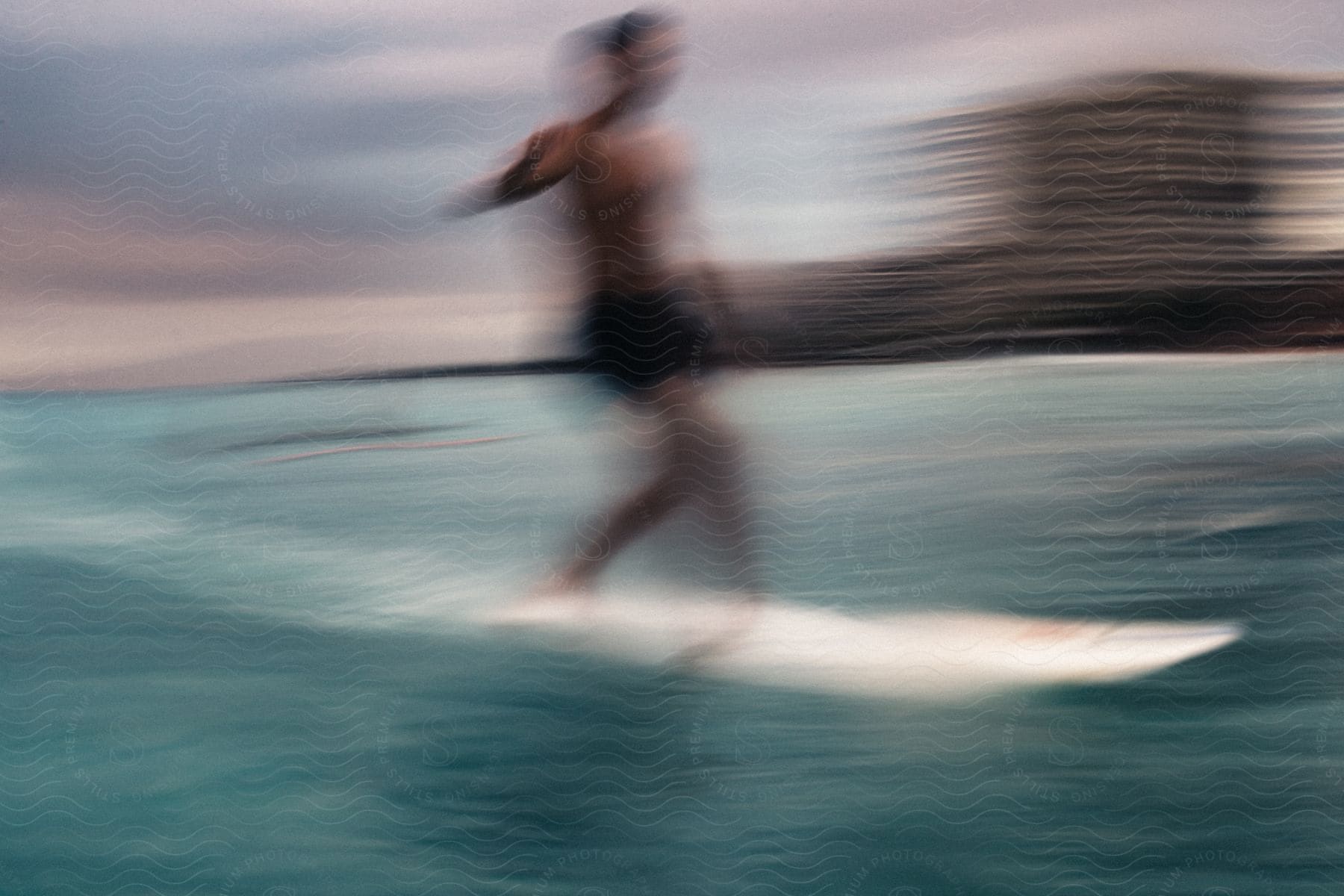 A man surfing on a white surfboard on the ocean