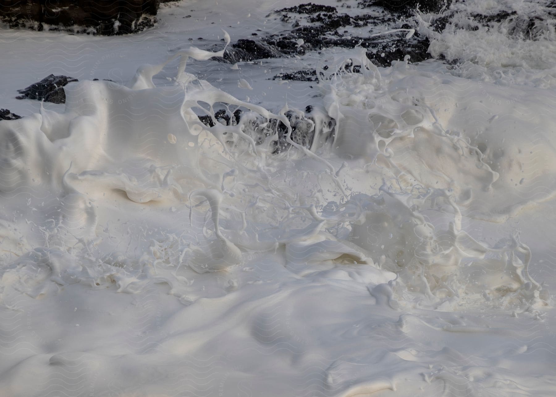 Sea foam crashes against rocks along the oregon coast
