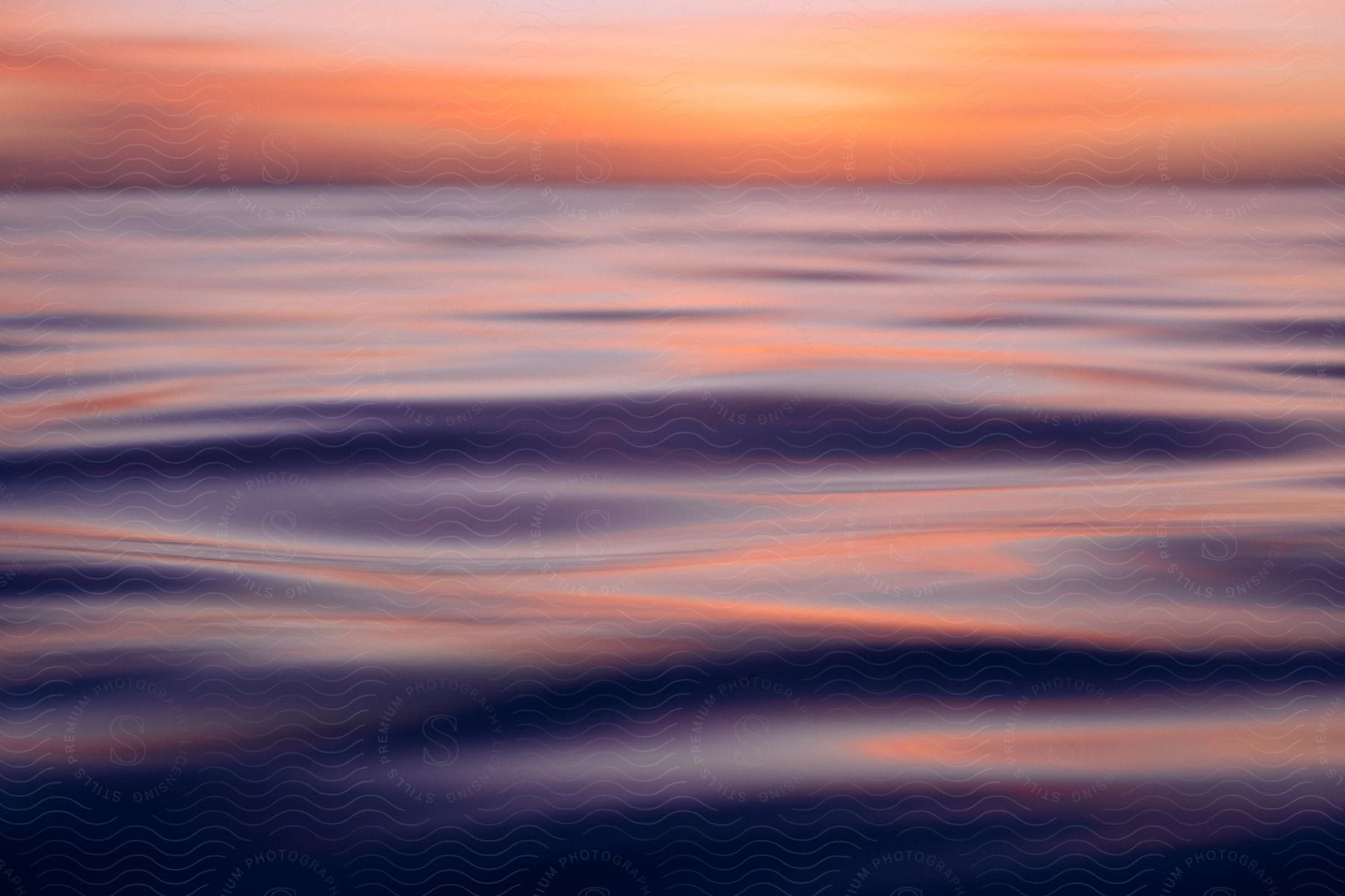 Distorted blurred shot of water ripples and the sky at dusk