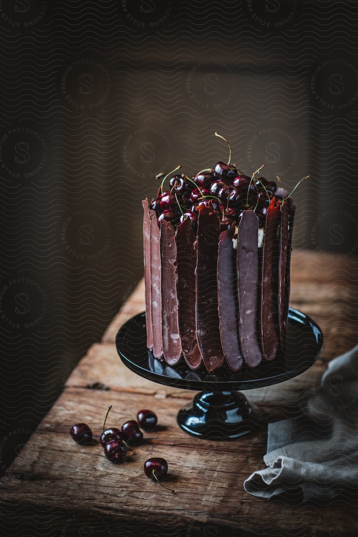 A cherry cake with a chocolate border on a display plate