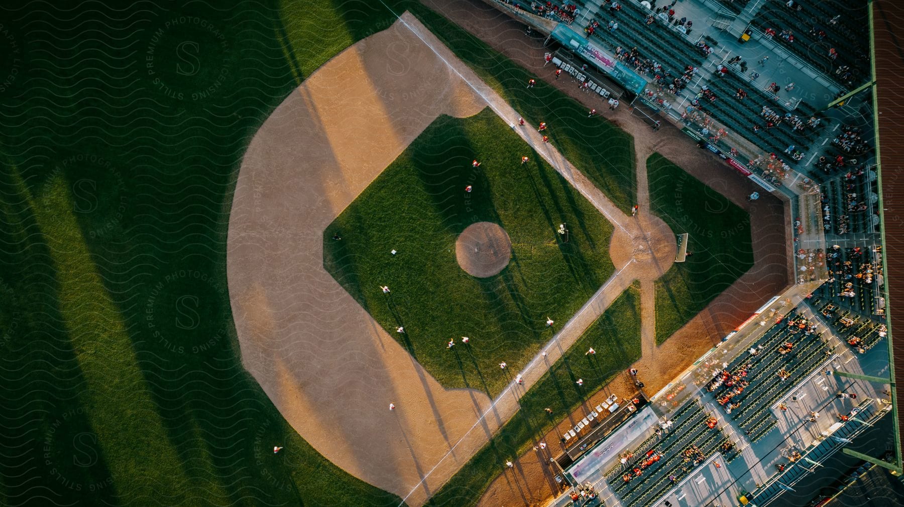 Aerial view of a baseball stadium with players on the field and people in the stands