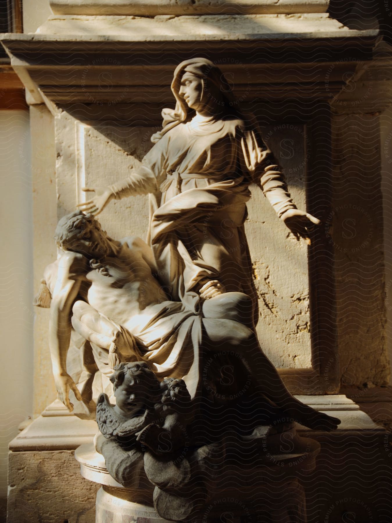 marble statue of christ and mary with angels inside a classical style building