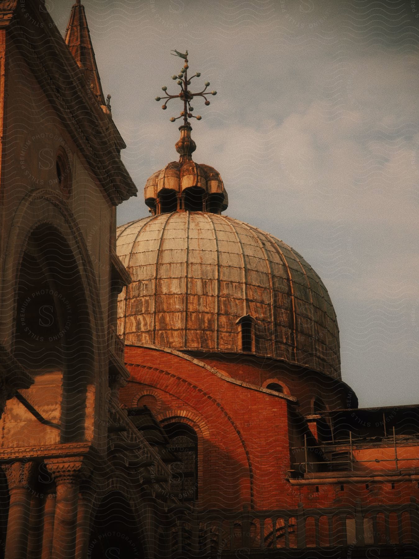 A tall dome on top of a building with clouds behind it