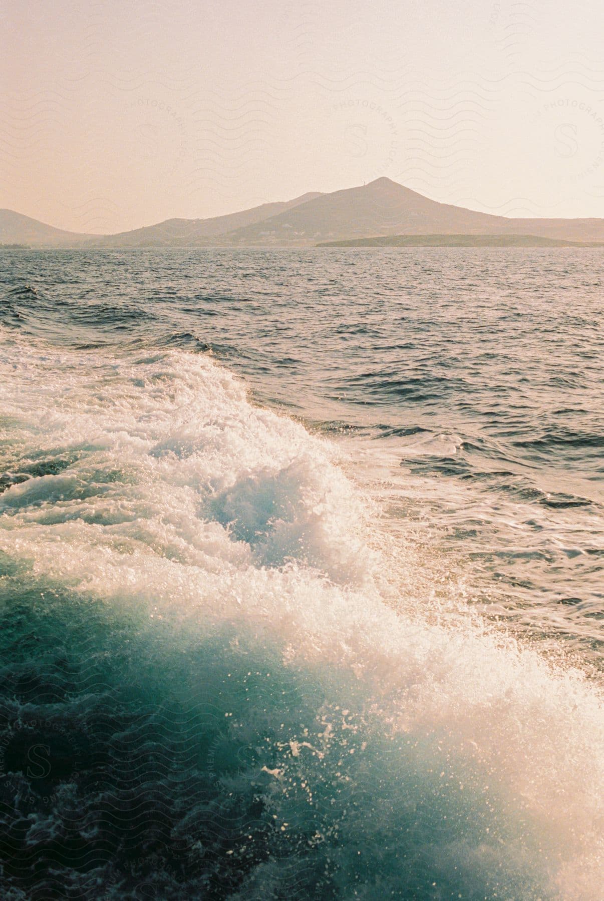 A view of water in the ocean with a medium size wave.