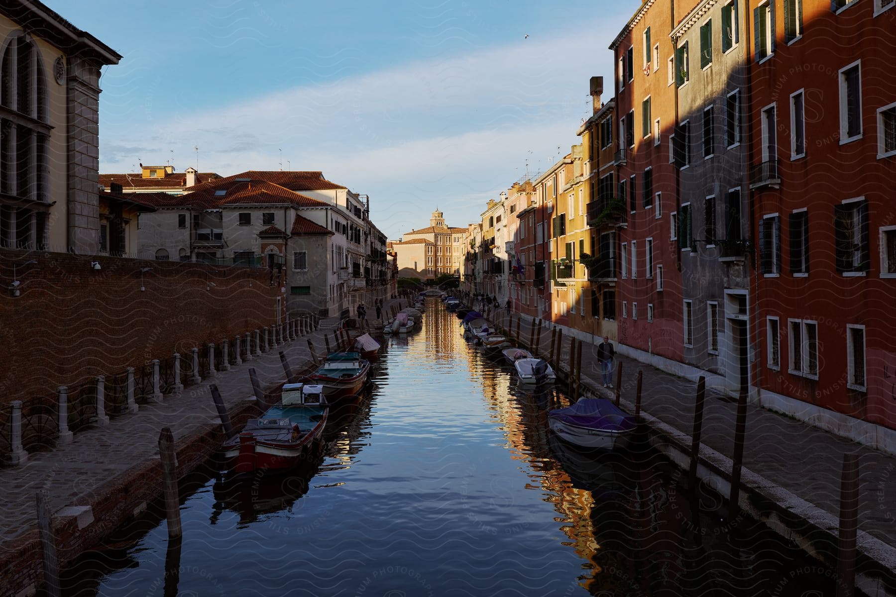 A water canal in the center of a Venice street.