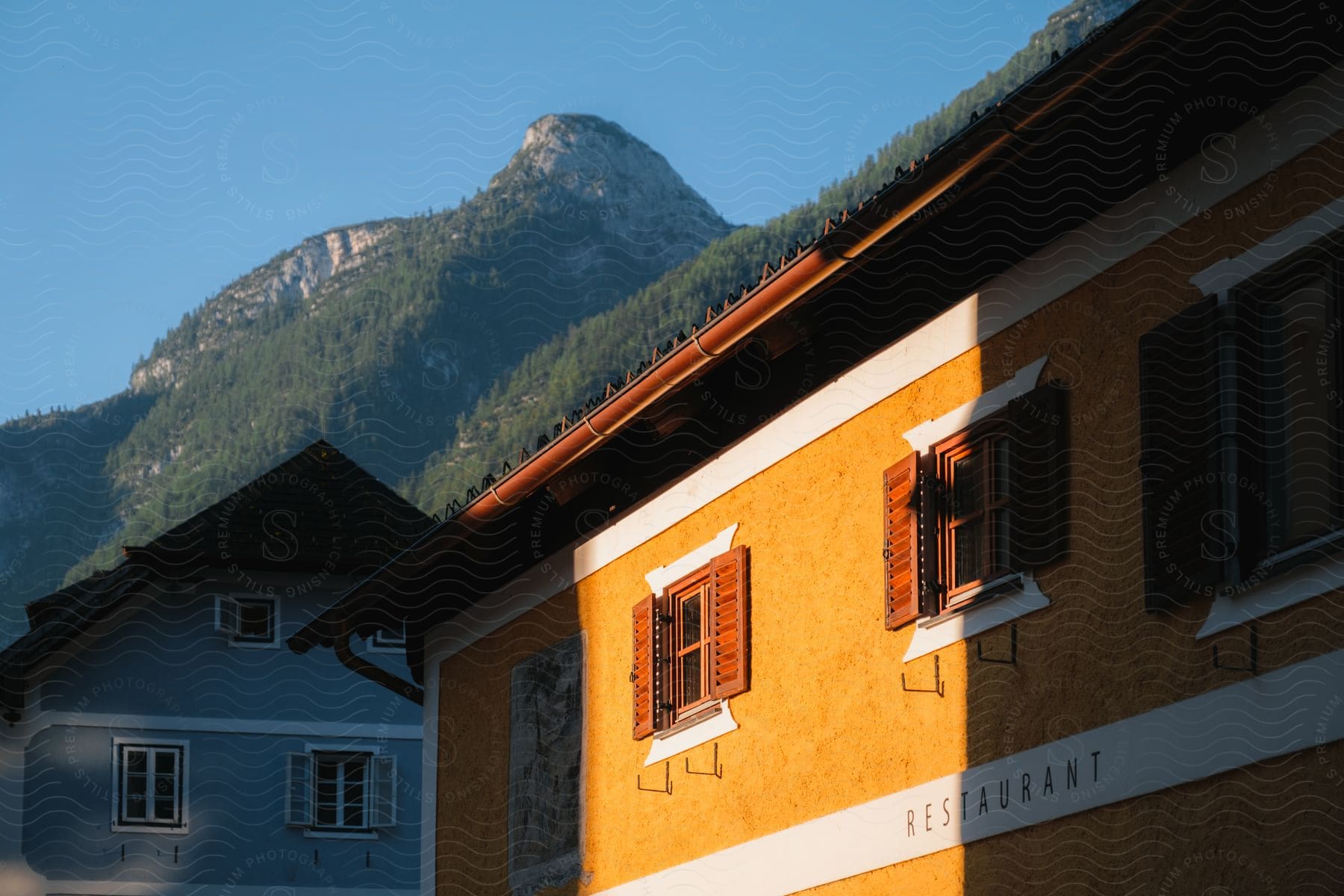 A building outdoors in a rural area with the sunlight shining on it