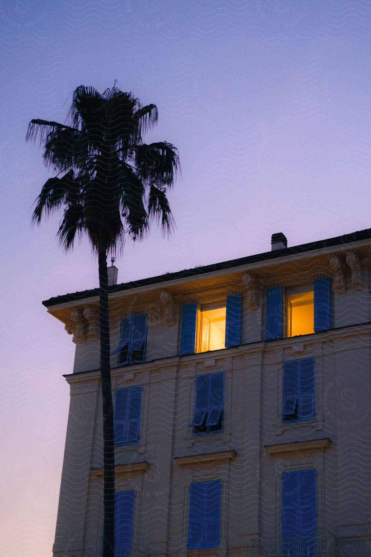 Building with yellow walls and blue wooden windows.