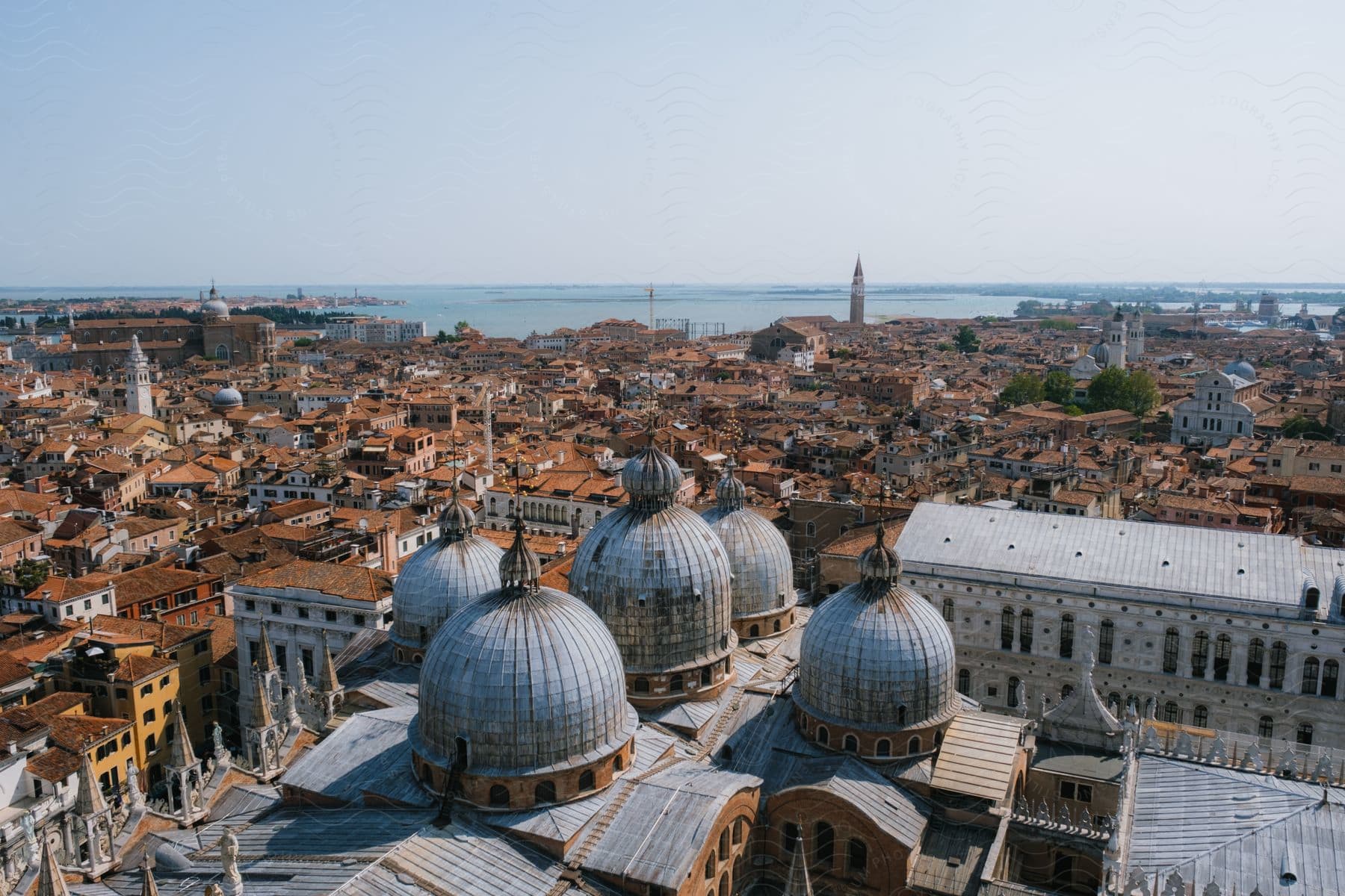 Domed ceiling buildings rise above an old city.