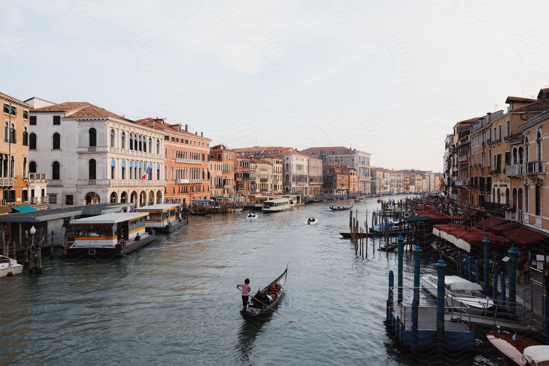 Gondolas river boats and docks on the Grand Canal in Venice