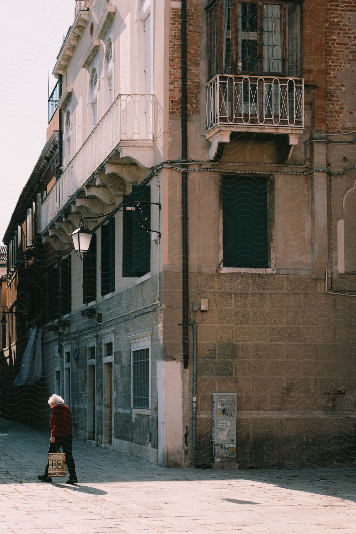 a woman walks past an apartment building