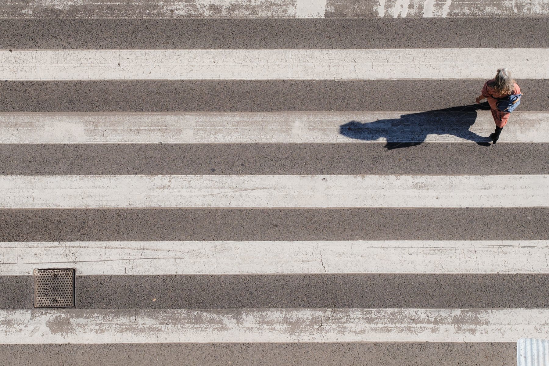 Woman crossing the crosswalk.