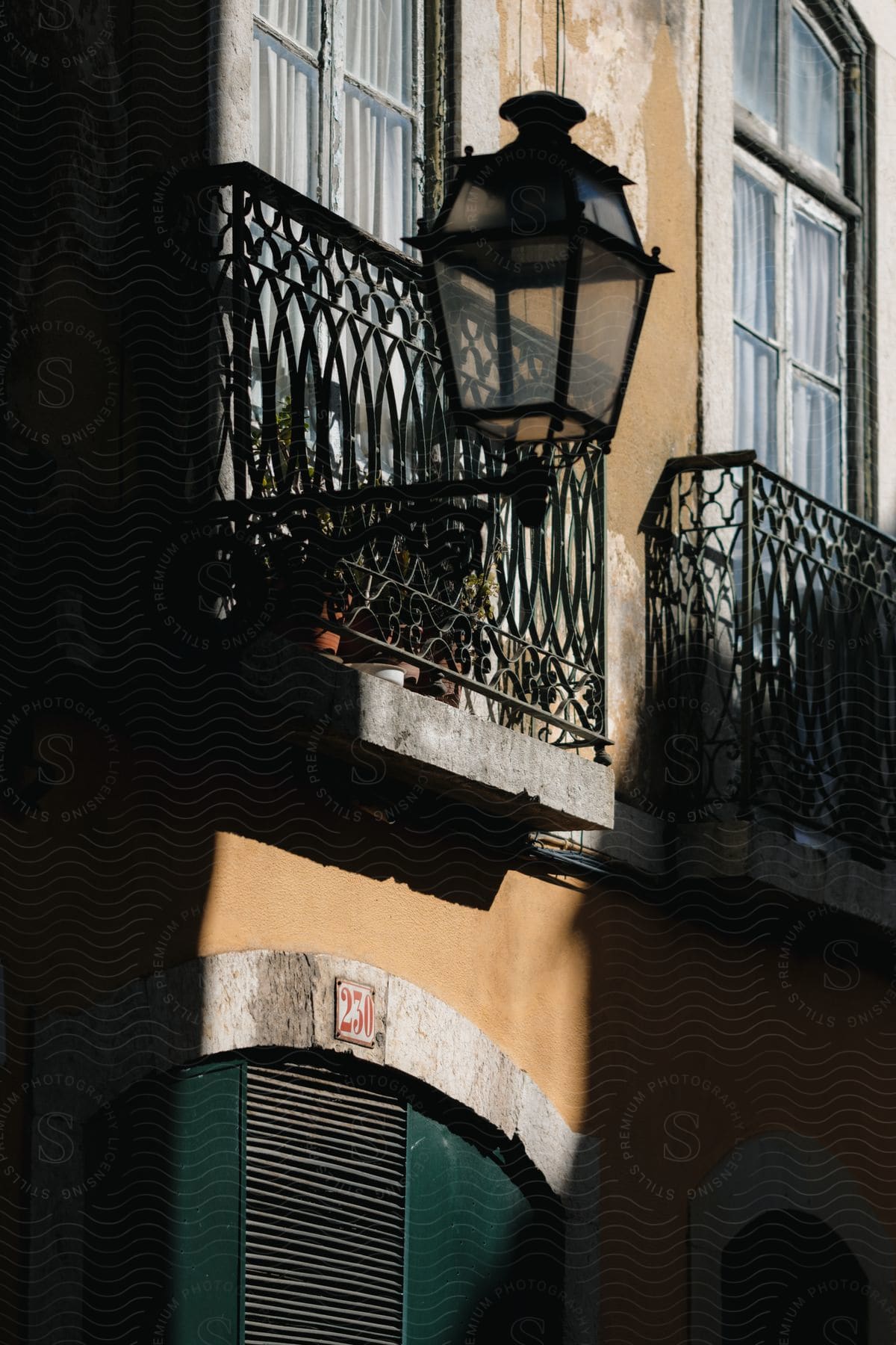 a street lamp sits outside an apartment building with juliette style balconies