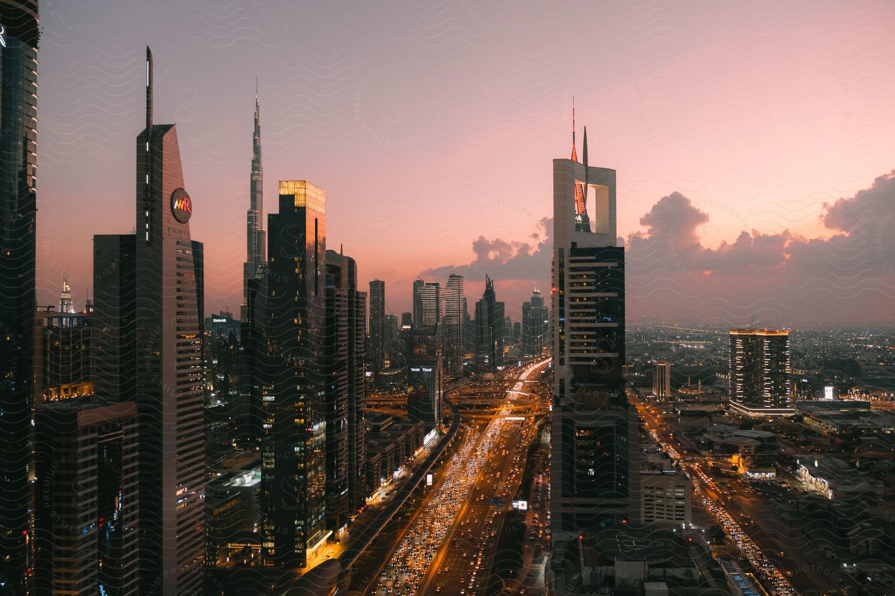 Sheikh Zayed Road at dusk, a futuristic city skyline with a busy street and tall skyscrapers.