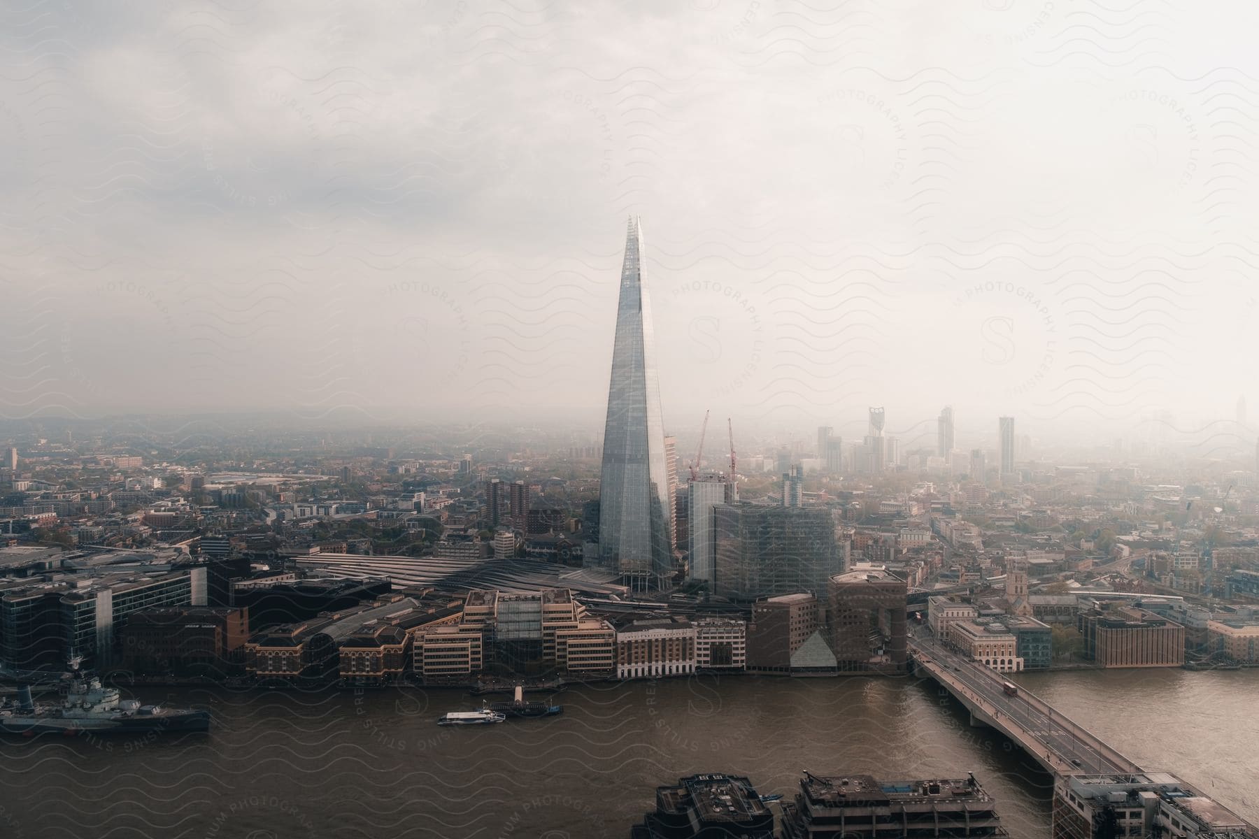 heavy fog settles over a city along a river