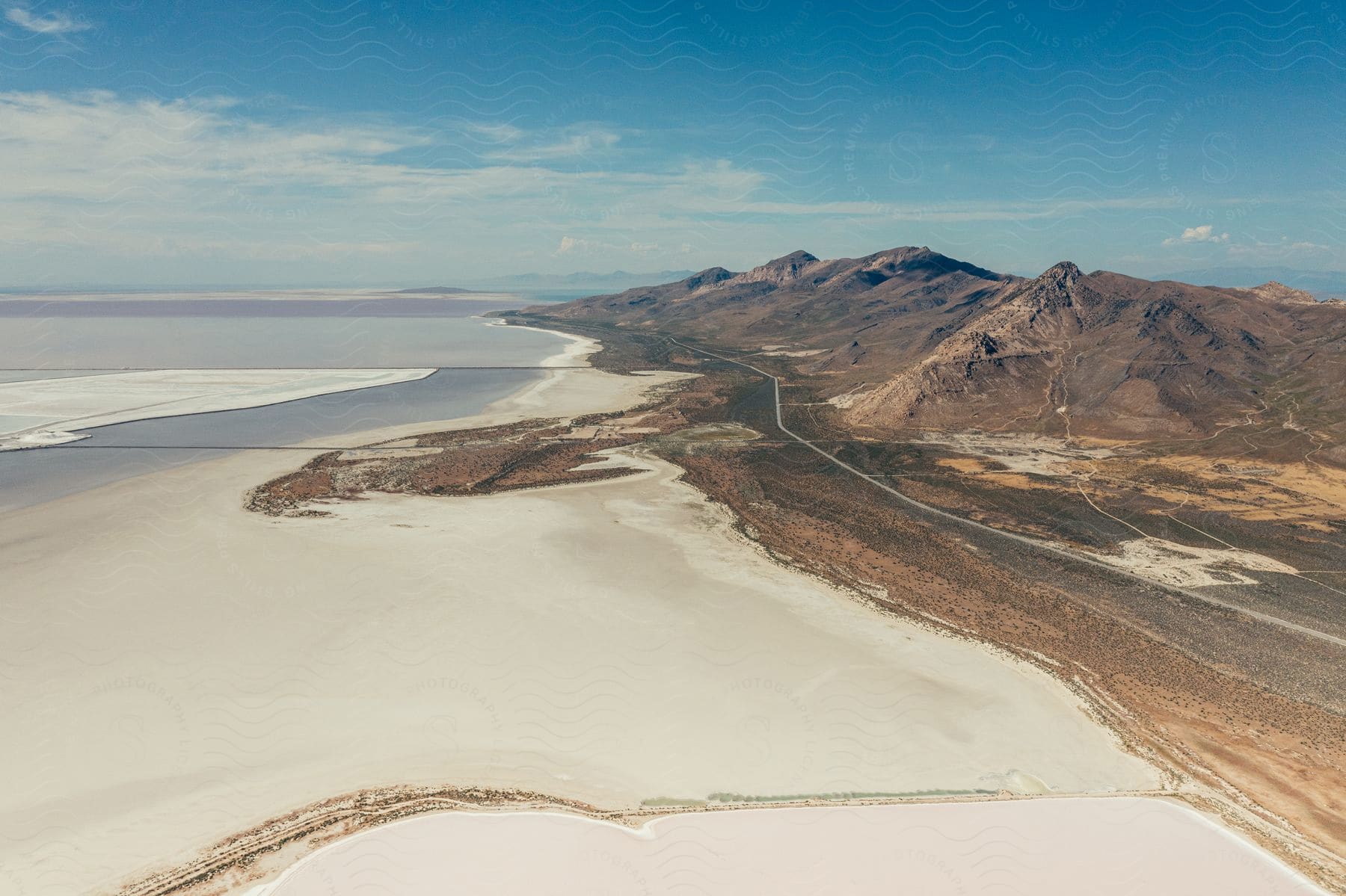 An aerial view of a water body with mountains visible in a distance.