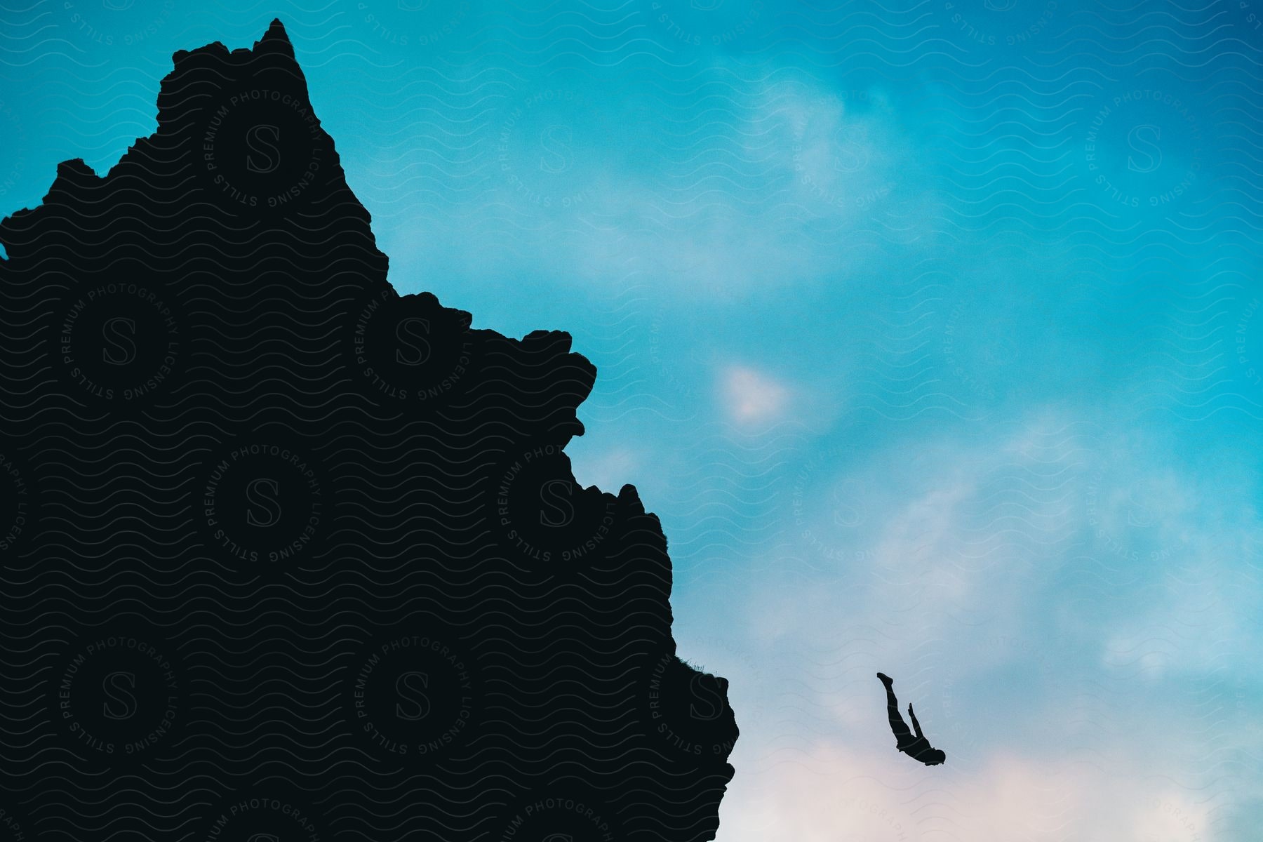 Silhouette Of A Person Cliff Diving