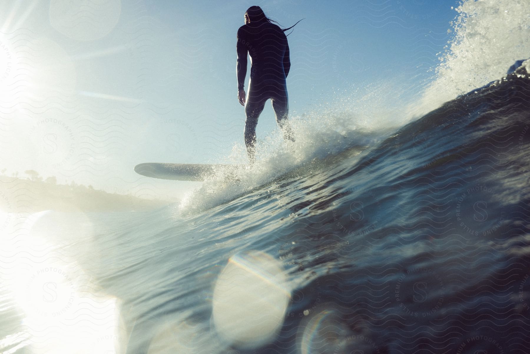 Man on a surfboard catching a wave.