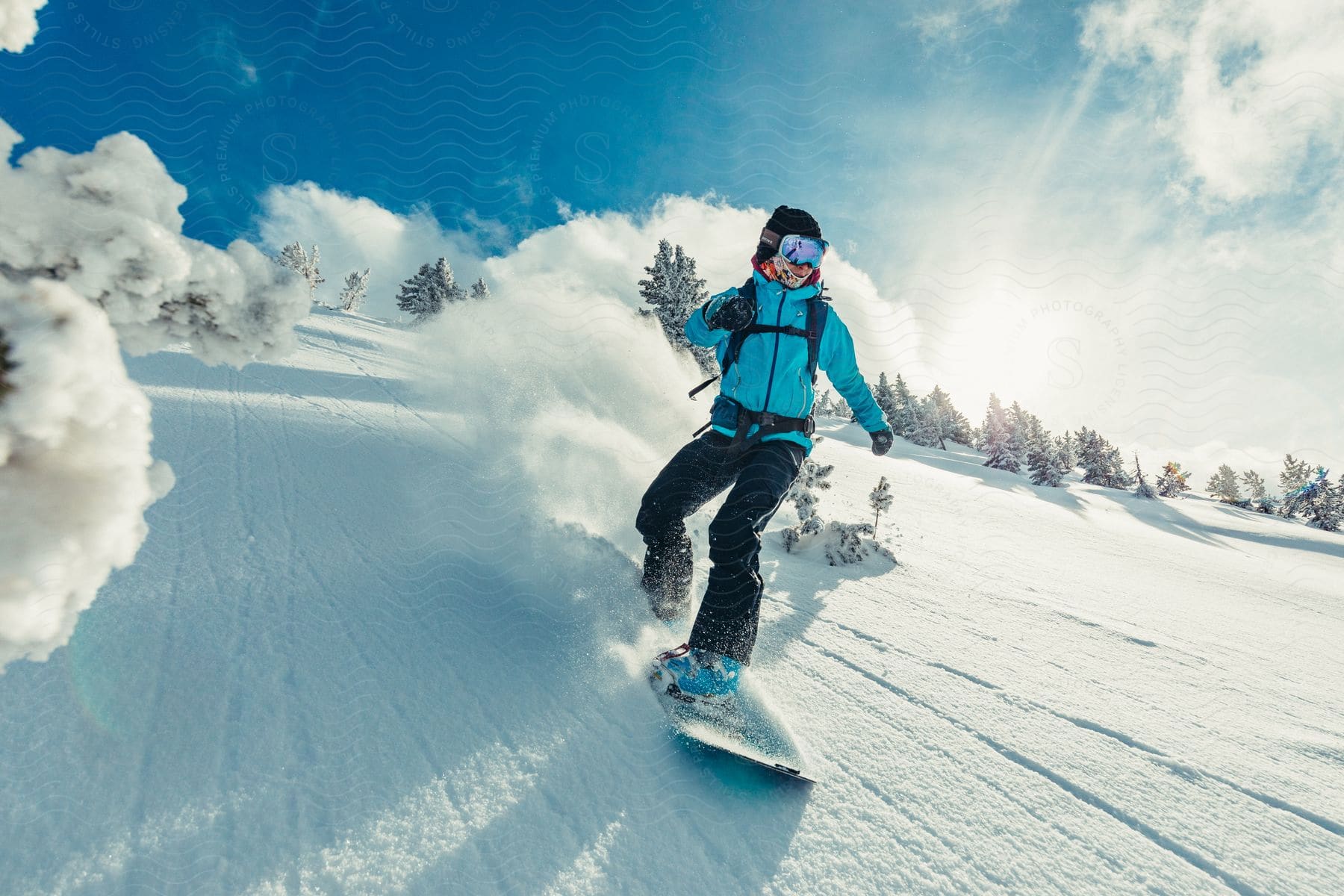 a snowboarder rides down the side of a mountain