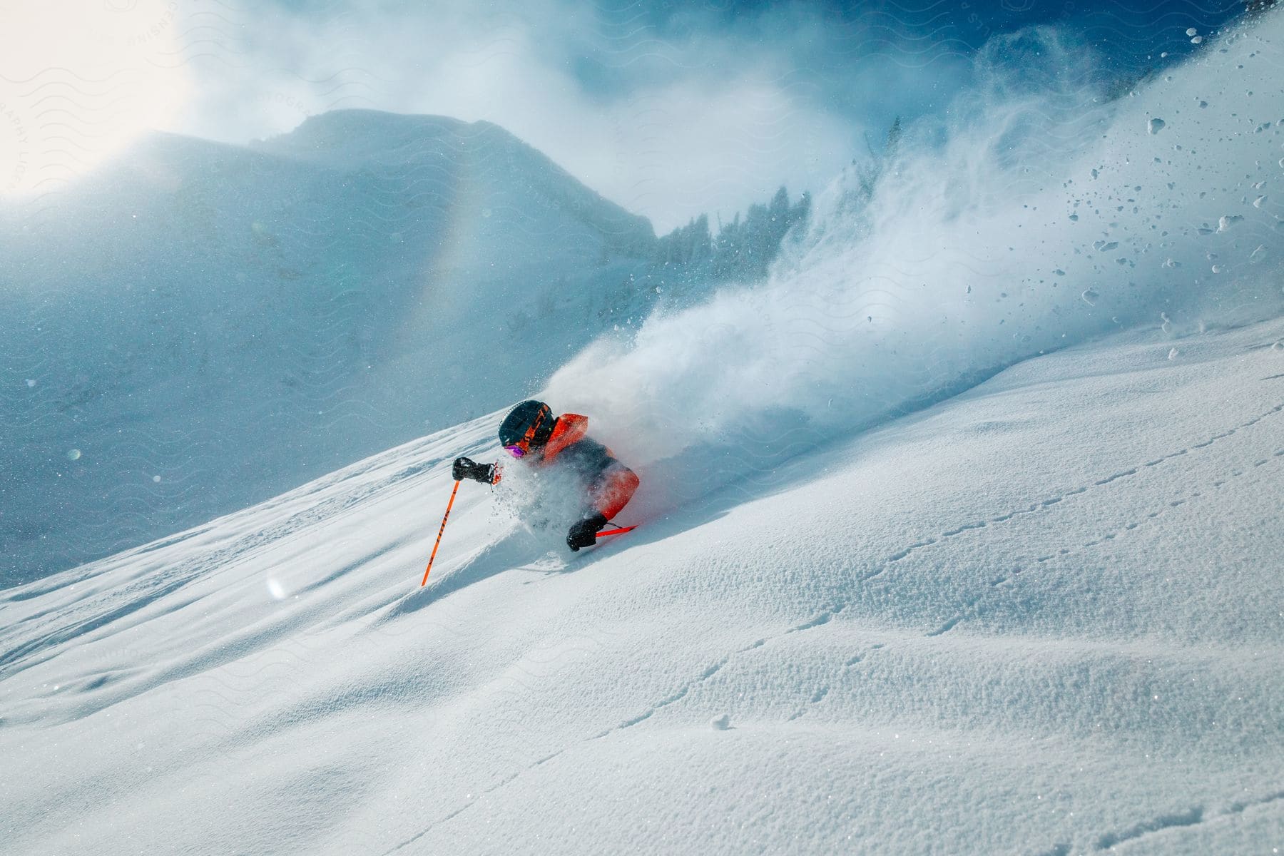 A skier going down a slope so fast, they're getting buried in the snow.